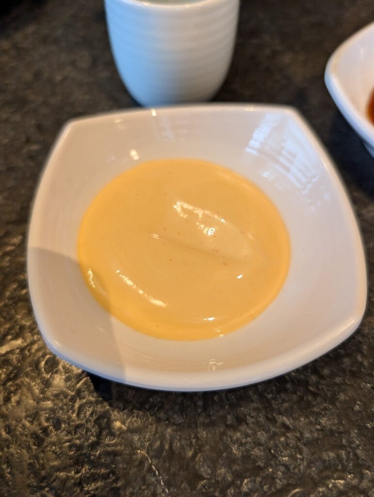 The dollar side of spicy mayo, thin enough to read as a dressing rather than a sauce.