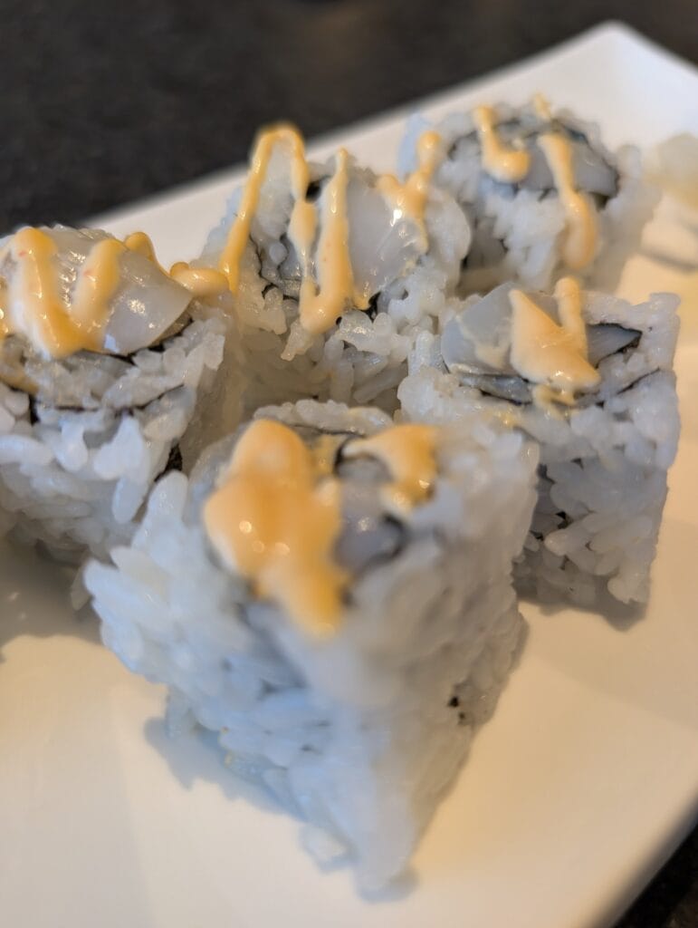 Raw scallop and spicy mayo in the six piece spicy scallop roll, the first thing we ordered.