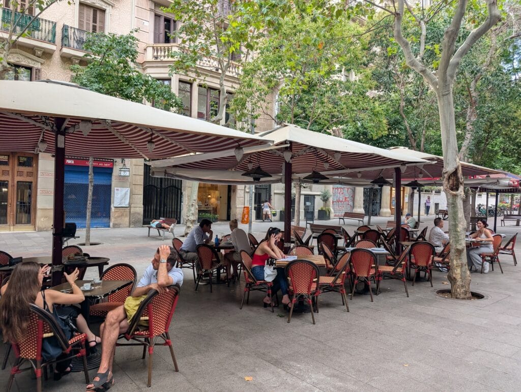 Shaded pavement terraces on Carrer d'Enric Granados in Barcelona