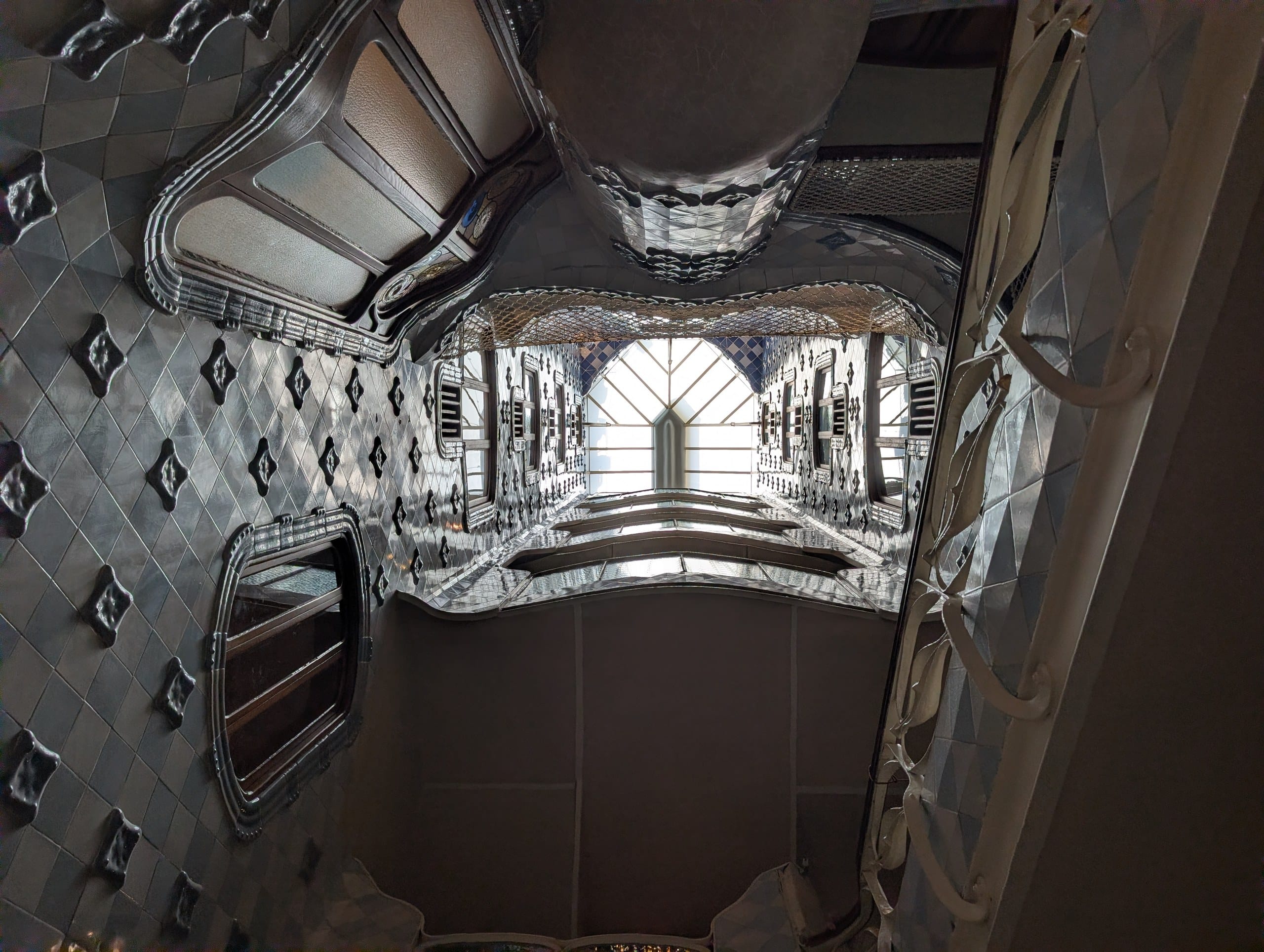 Looking up through the mirrored stairs atrium at Casa Batlló