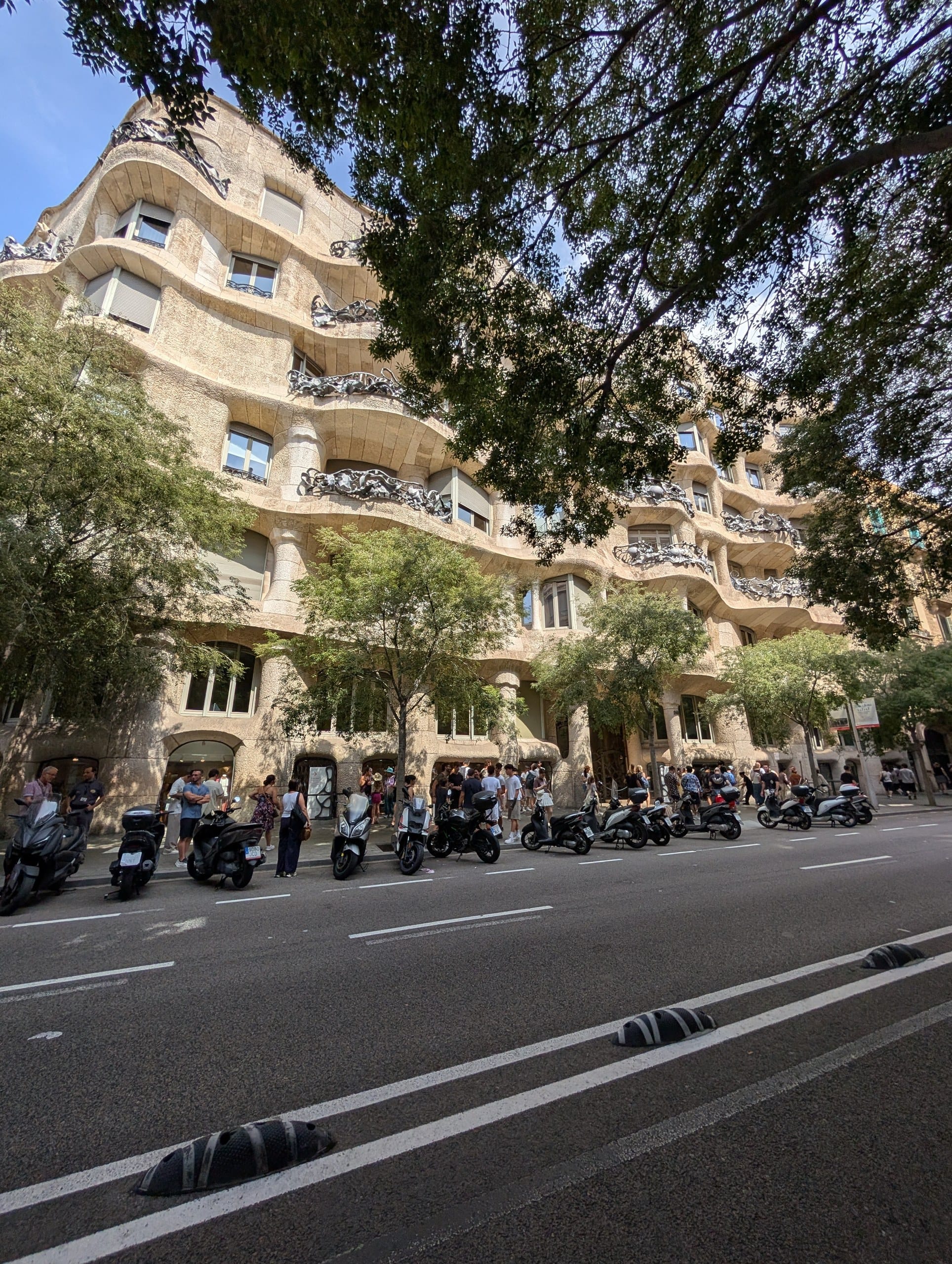 The rippling stone facade of Casa Milà seen from Passeig de Gràcia