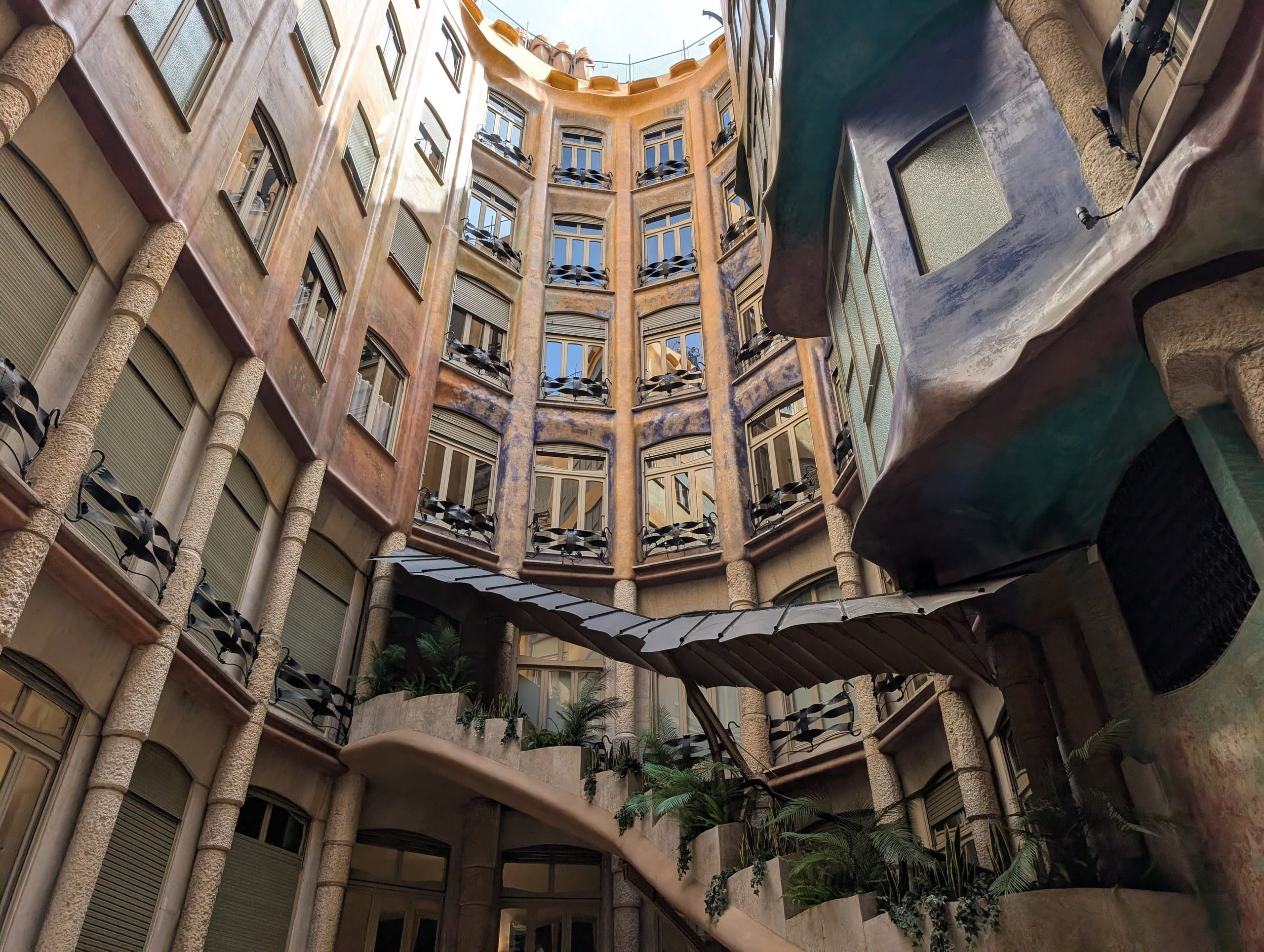 Looking up through the painted interior courtyard of Casa Milà