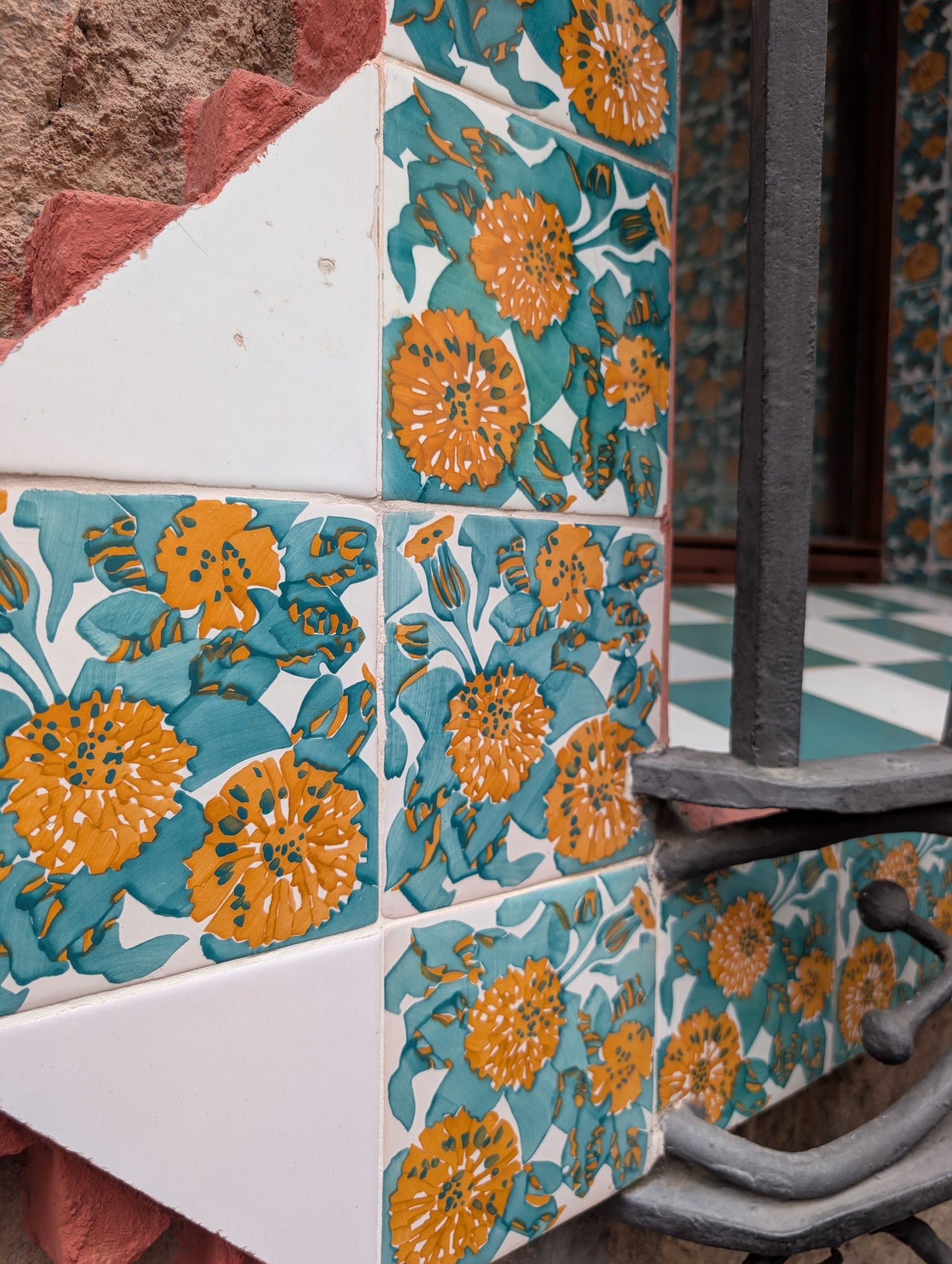 Orange marigold tiles wrapping the corner of the Casa Vicens facade