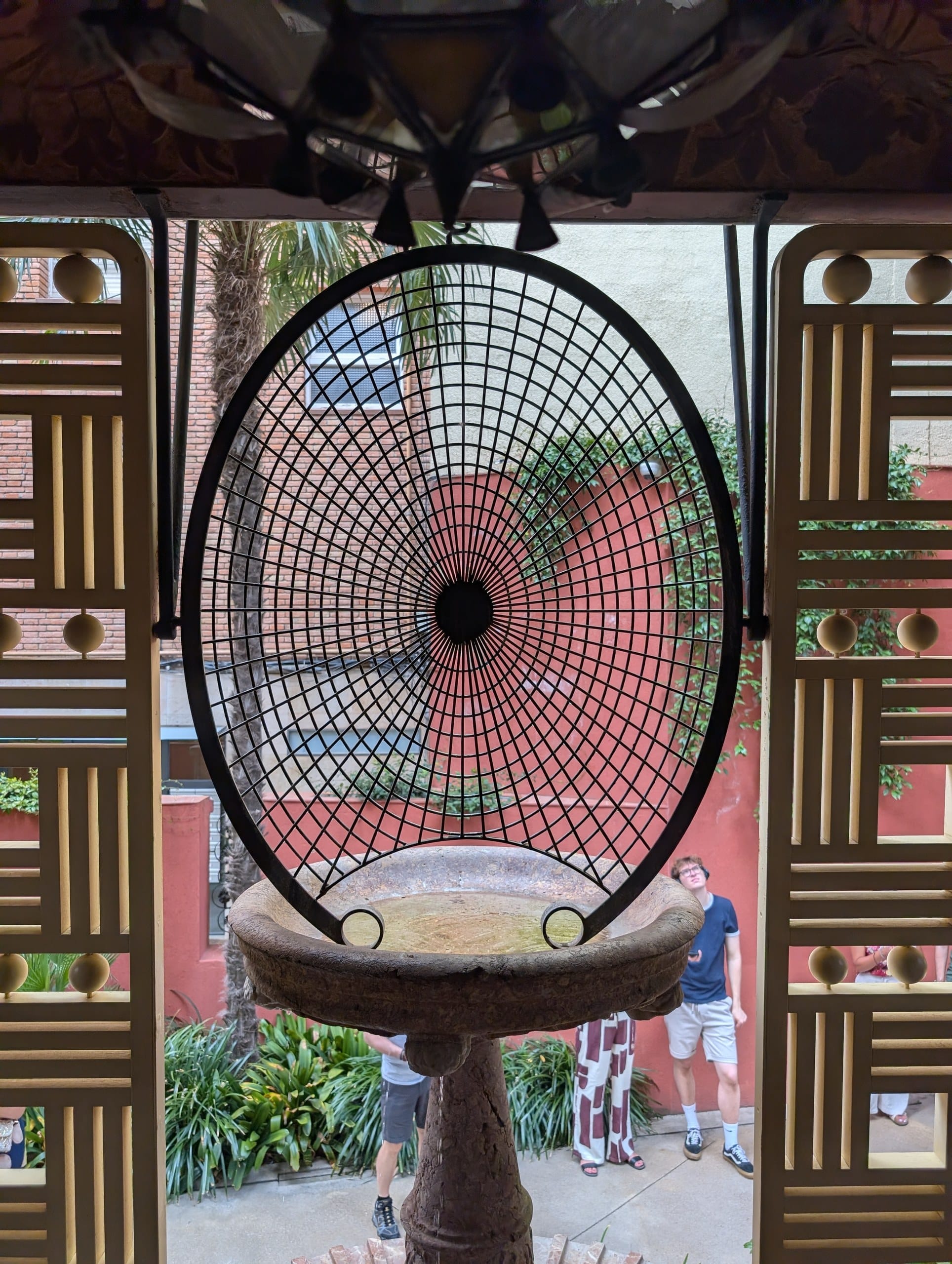 Round iron screen framing the courtyard at Casa Vicens