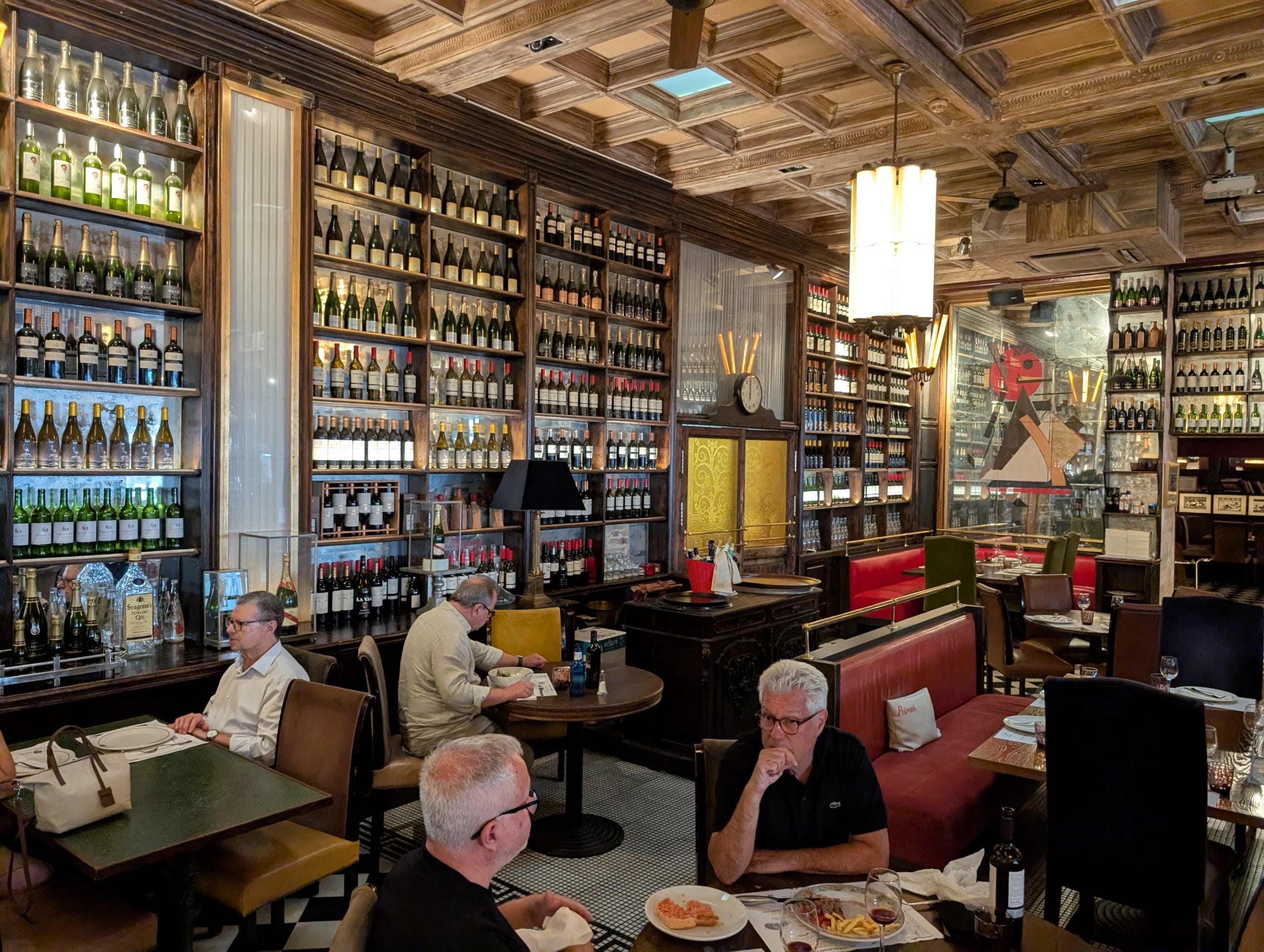The dining room at Cheri Barcelona, walls lined with bottles