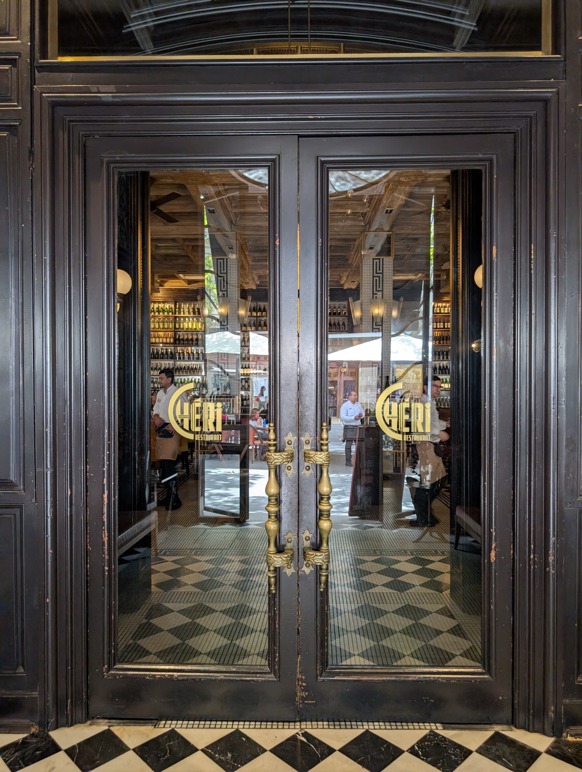 The timber and glass entrance doors of Cheri Barcelona
