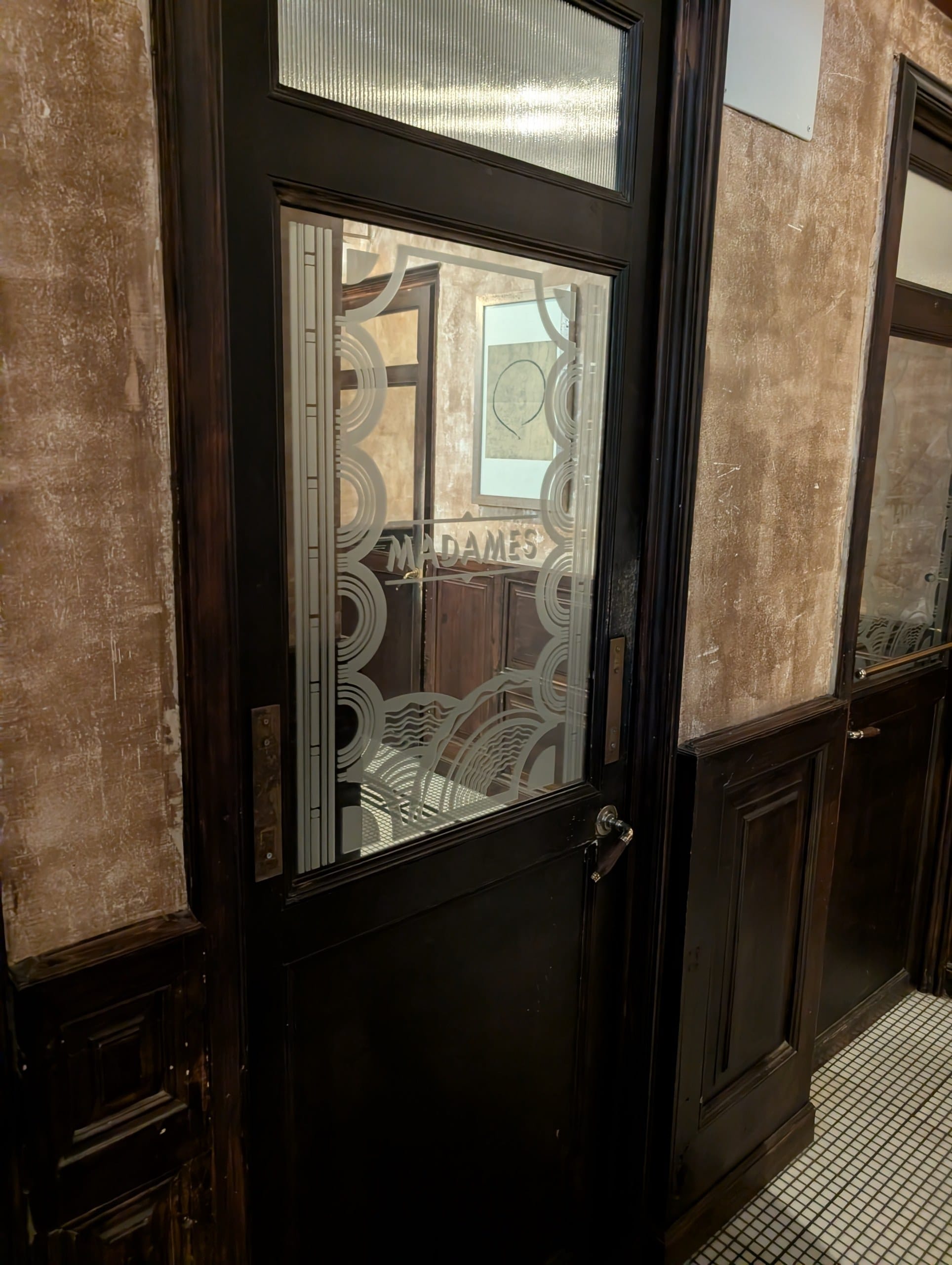 A glass panelled door inside Cheri Barcelona