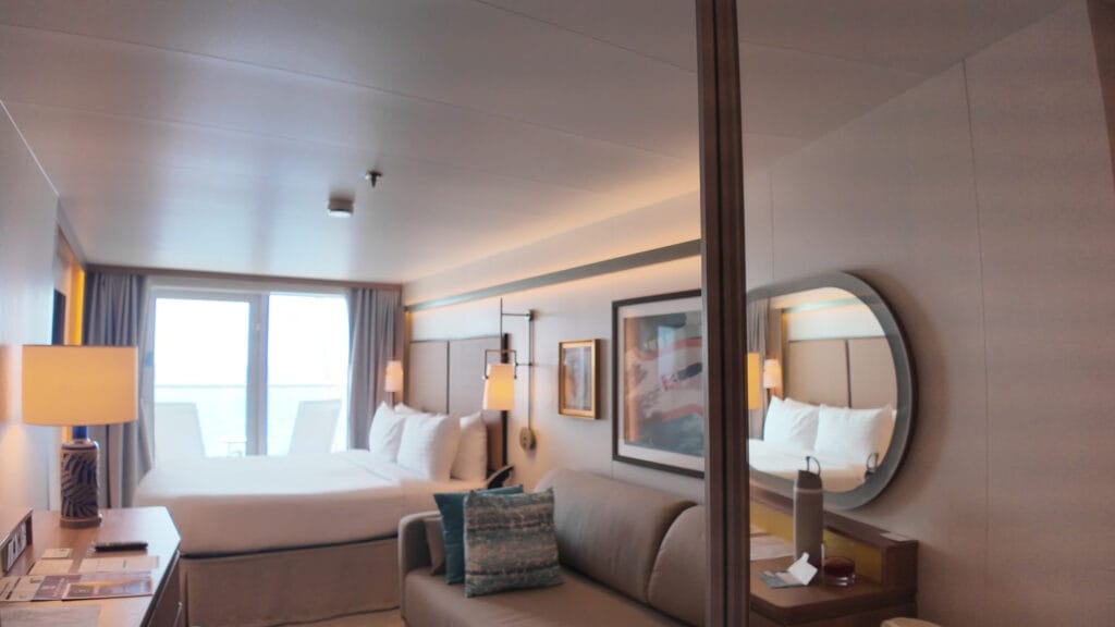 Stateroom 14632 on Legend of the Seas, the couch that becomes the third bed on the right and the main bed by the balcony window