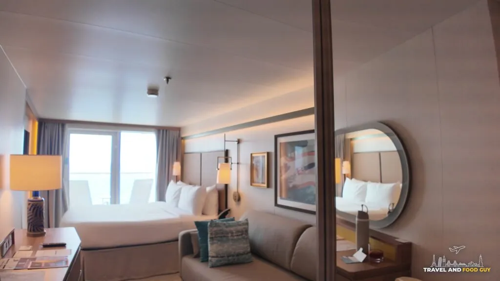 Stateroom 14632 on Legend of the Seas, the couch that becomes the third bed on the right and the main bed by the balcony window