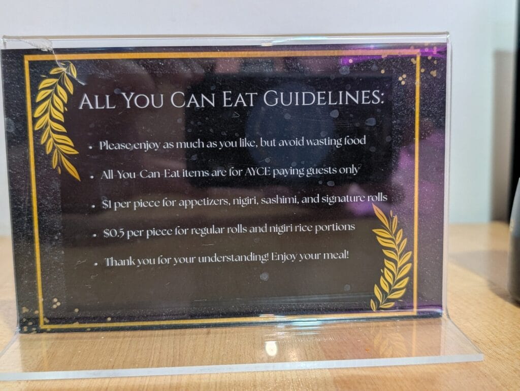 The table card at e Sushi setting out the all you can eat rules, including the charge for wasted food: one dollar a piece for appetizers, nigiri, sashimi and signature rolls, and fifty cents a piece for regular rolls and nigiri rice.