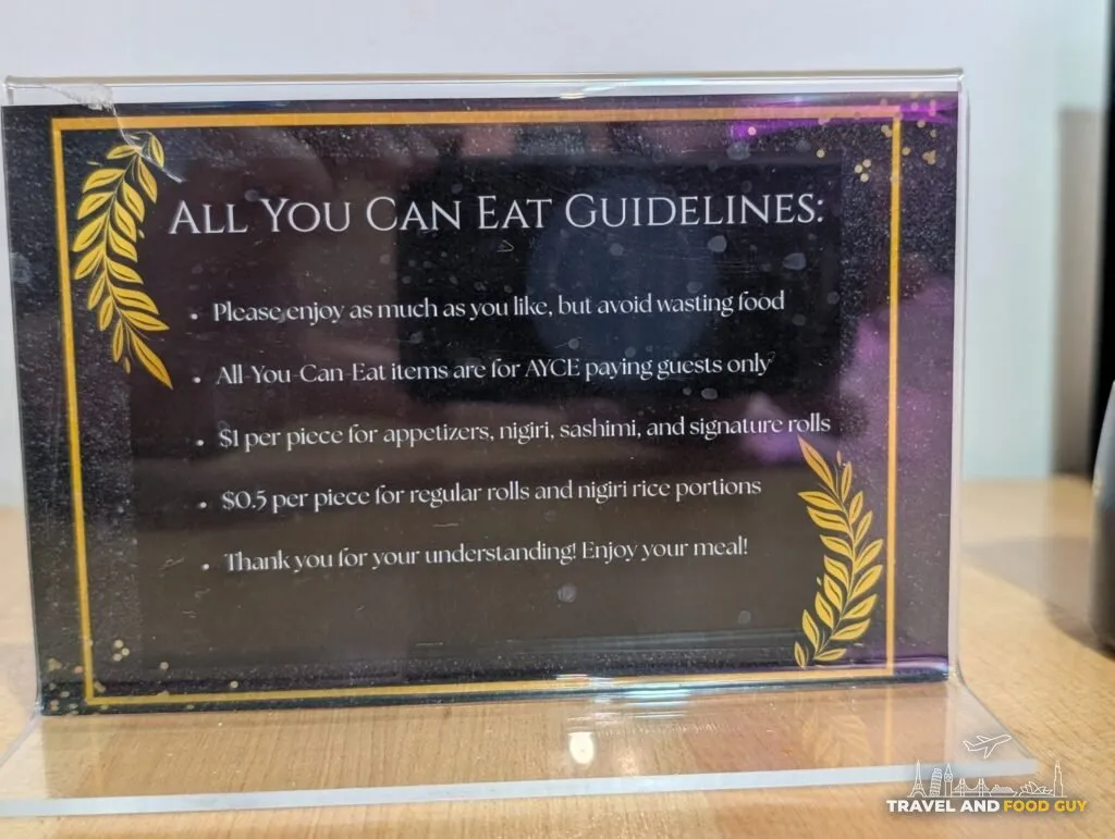 The table card at e Sushi setting out the all you can eat rules, including the charge for wasted food: one dollar a piece for appetizers, nigiri, sashimi and signature rolls, and fifty cents a piece for regular rolls and nigiri rice.
