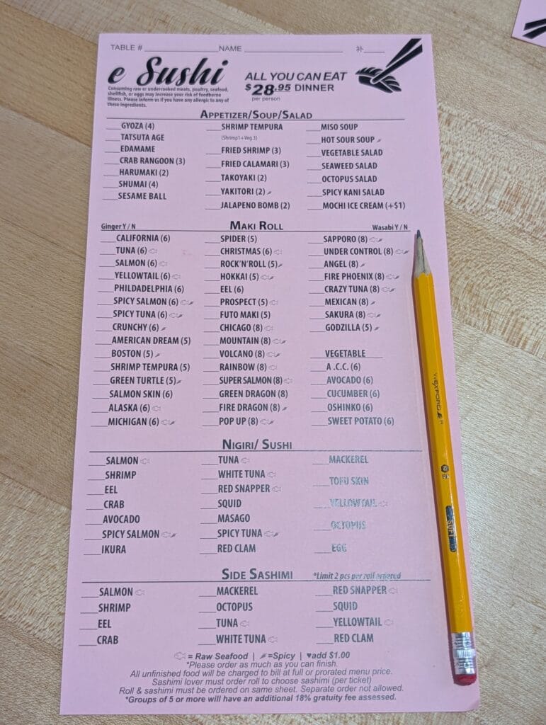 The pink all you can eat order sheet at e Sushi, priced at 28.95 dollars per person for dinner. You tick what you want in pencil and hand it over, round after round.