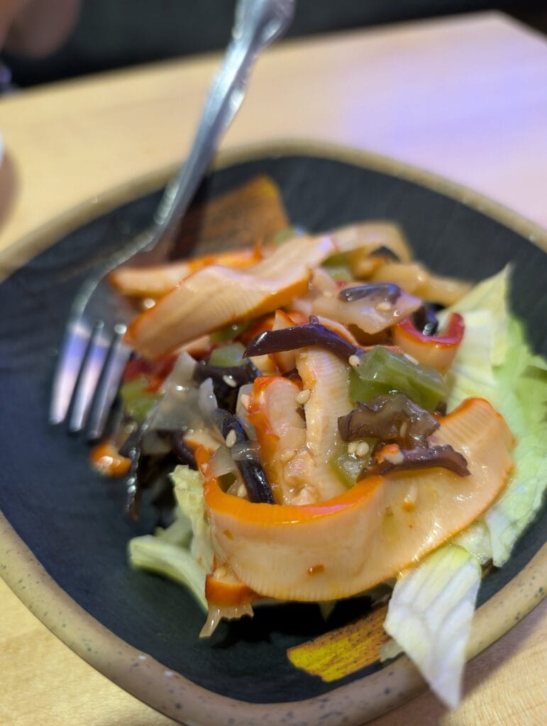 The octopus salad at e Sushi, sliced seafood with wood ear mushroom, green pepper, onion and sesame in a light chili oil dressing over shredded lettuce.