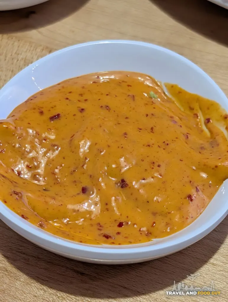 A side bowl of the spicy mayo at e Sushi, a dressing style sauce rather than the usual sriracha and Japanese mayonnaise mix.