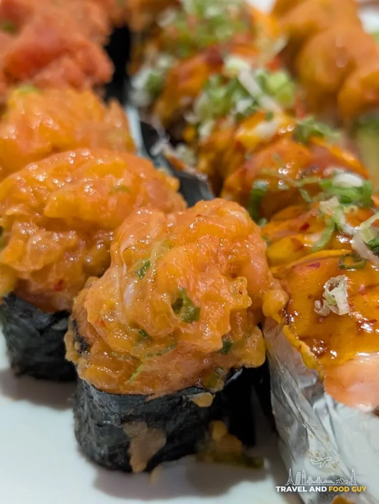 The spicy salmon gunkan at e Sushi, minced rather than chopped, mounded over rice in a nori collar.