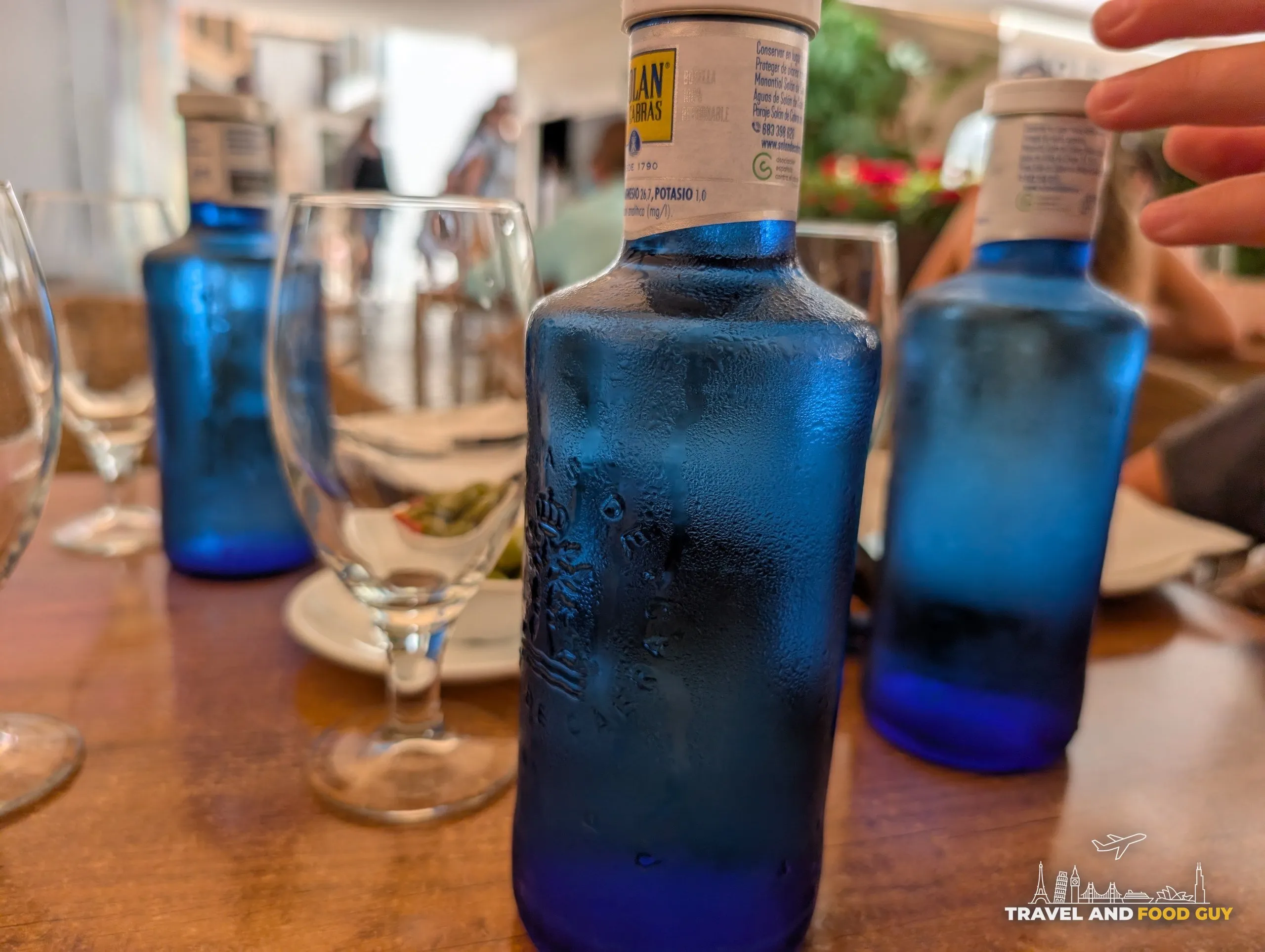 Blue bottles of still water on the table at El Pimpi in Málaga