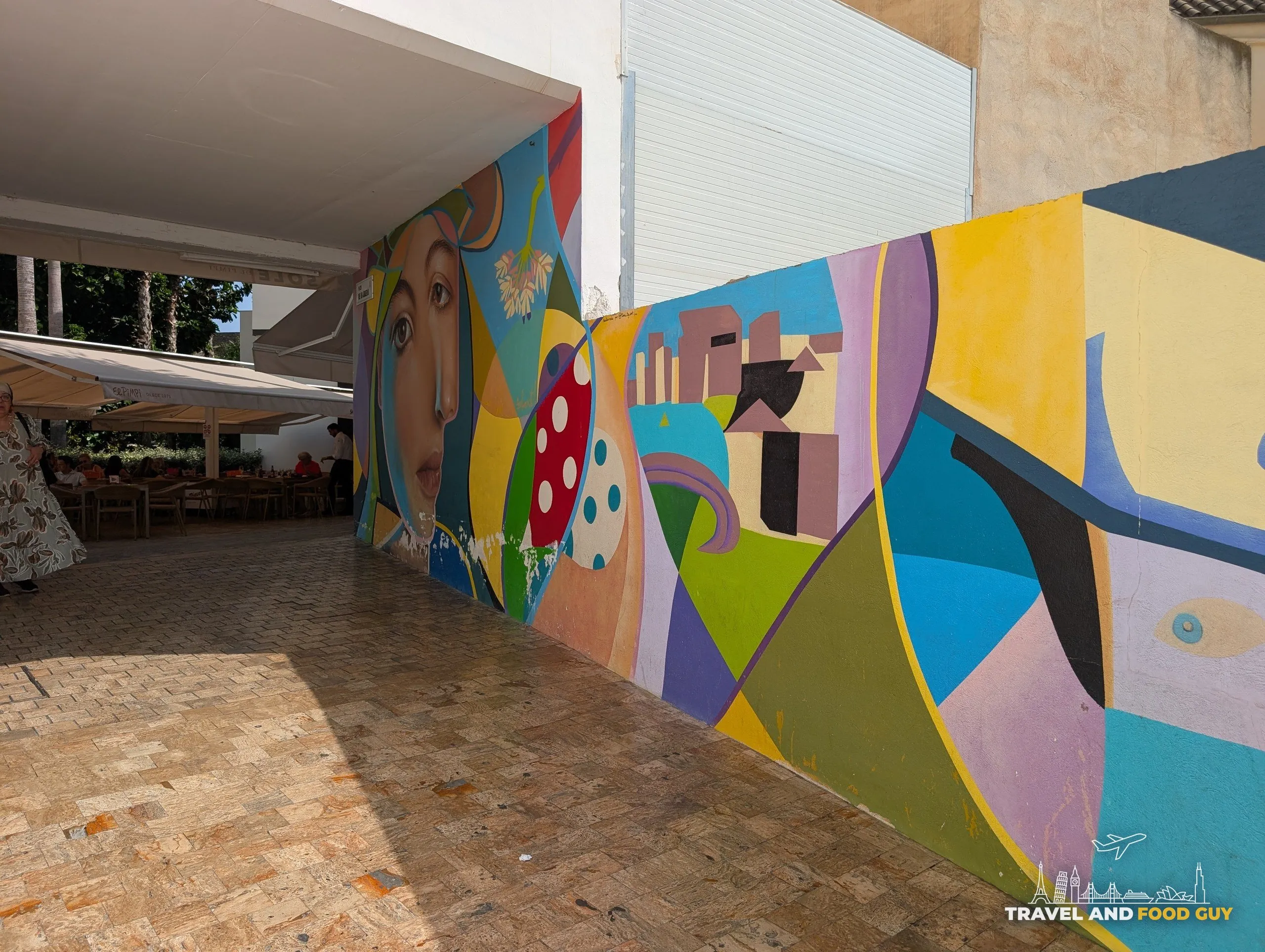Colorful cubist style mural on the wall leading out to the El Pimpi terrace in Málaga