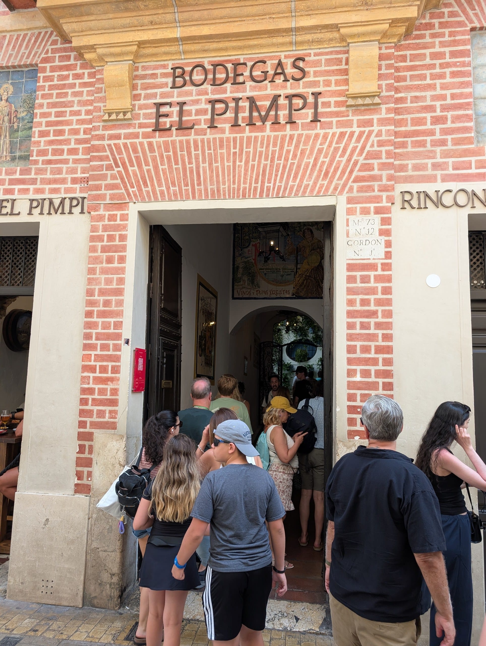 Crowd at the Bodegas El Pimpi entrance on Calle Granada in Málaga