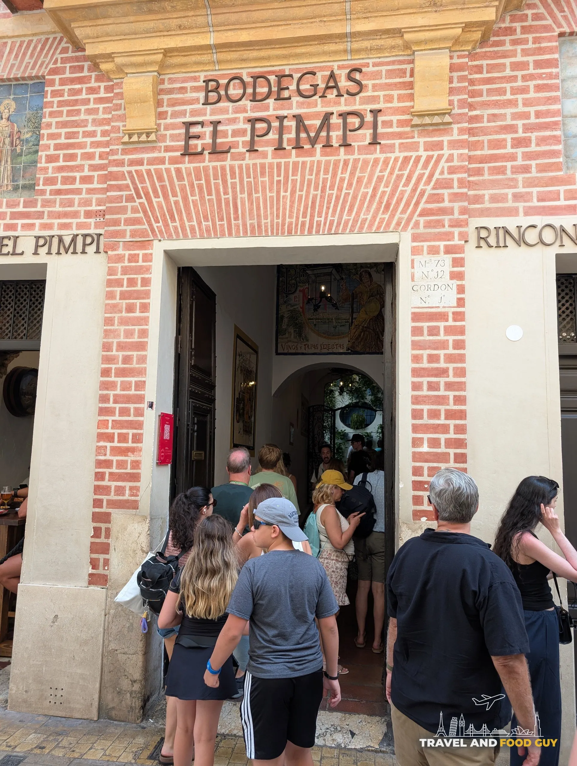 Crowd at the Bodegas El Pimpi entrance on Calle Granada in Málaga