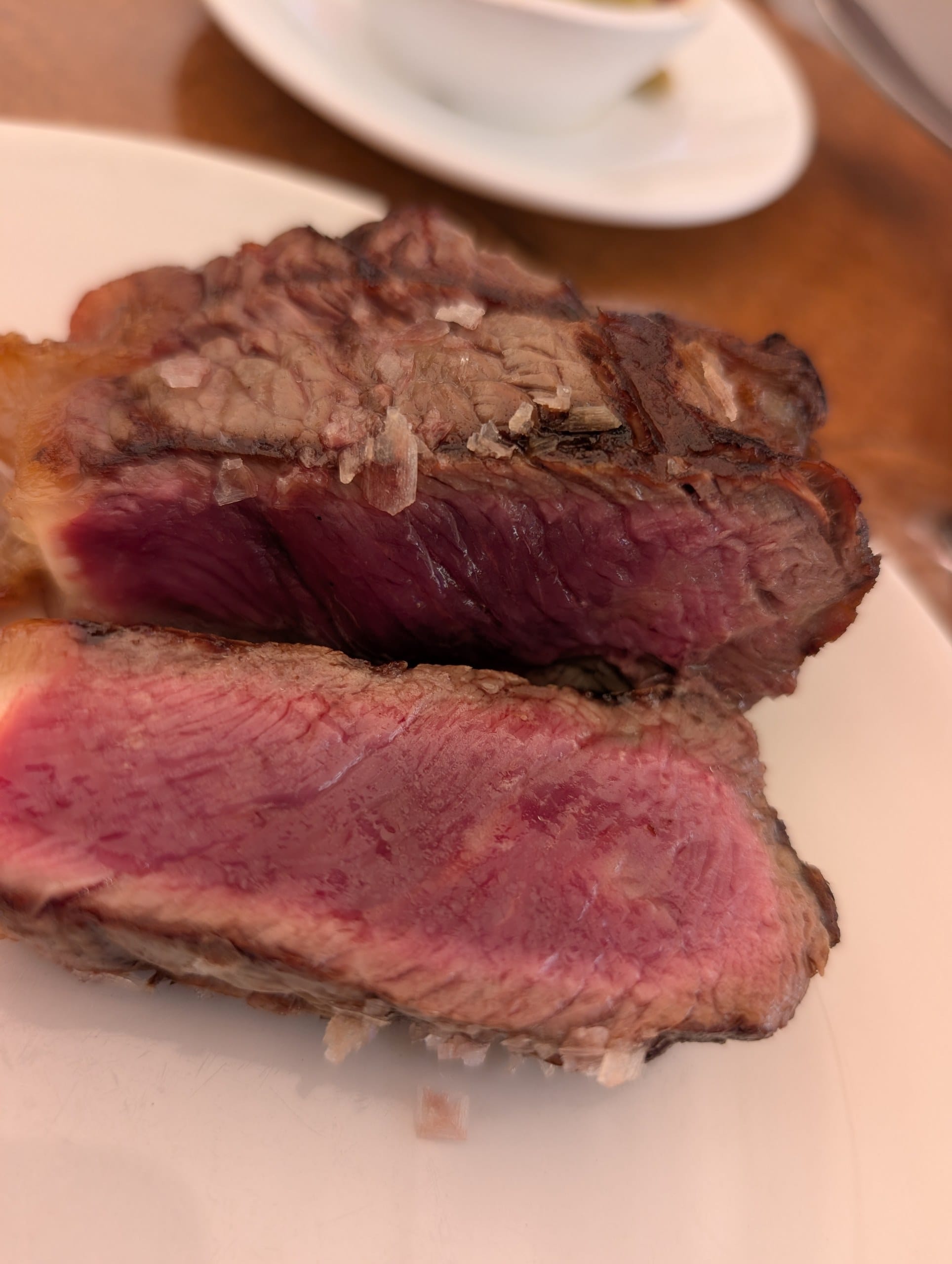 Sliced aged beef sirloin showing a pink center at El Pimpi in Málaga