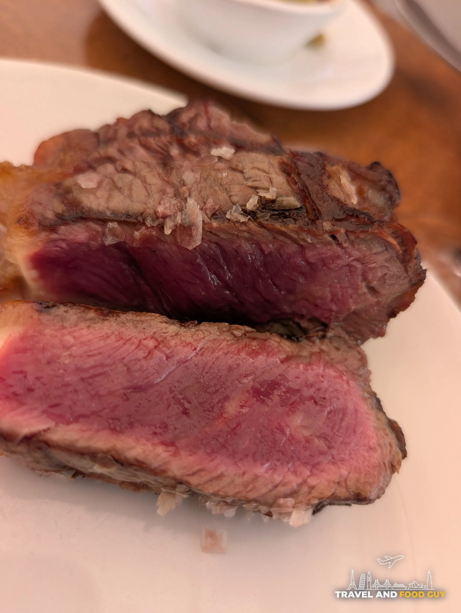 Sliced aged beef sirloin showing a pink center at El Pimpi in Málaga
