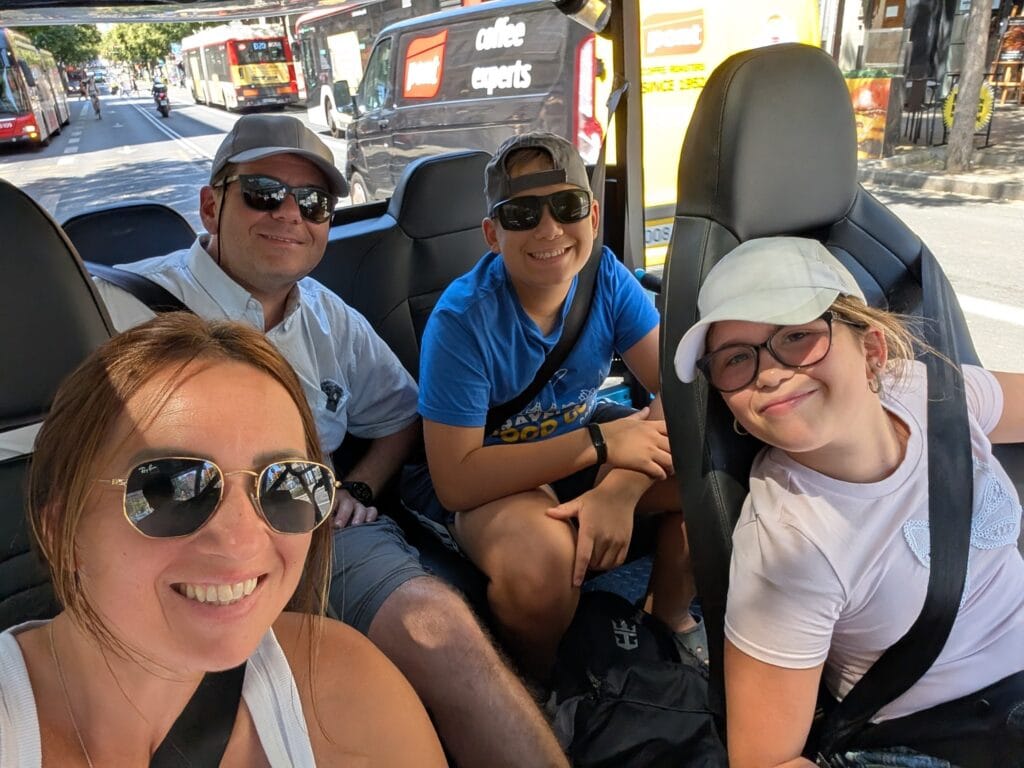 Family selfie inside the HolaTukTuk with Vika, Josh, and Emily in the two seat rows
