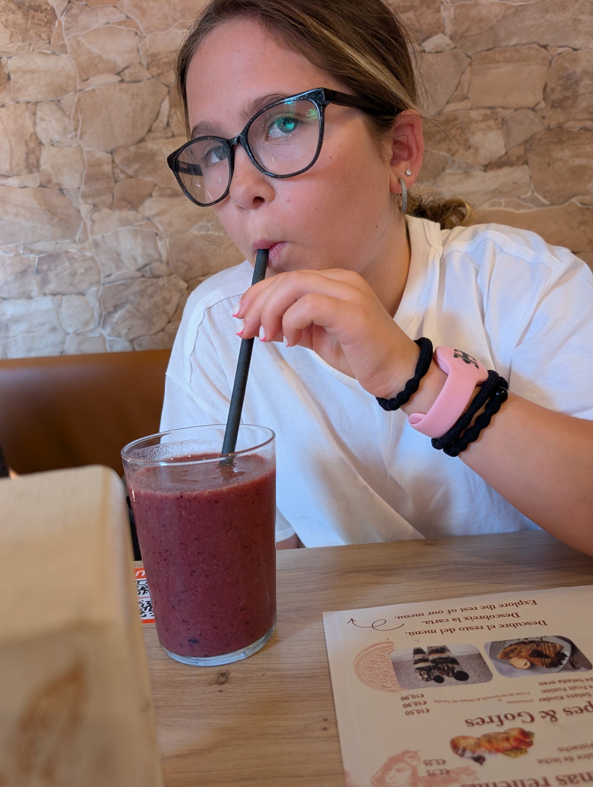 Emily drinking a Red Berries Antiox smoothie made with fresh fruit at Ferretti Poble Nou