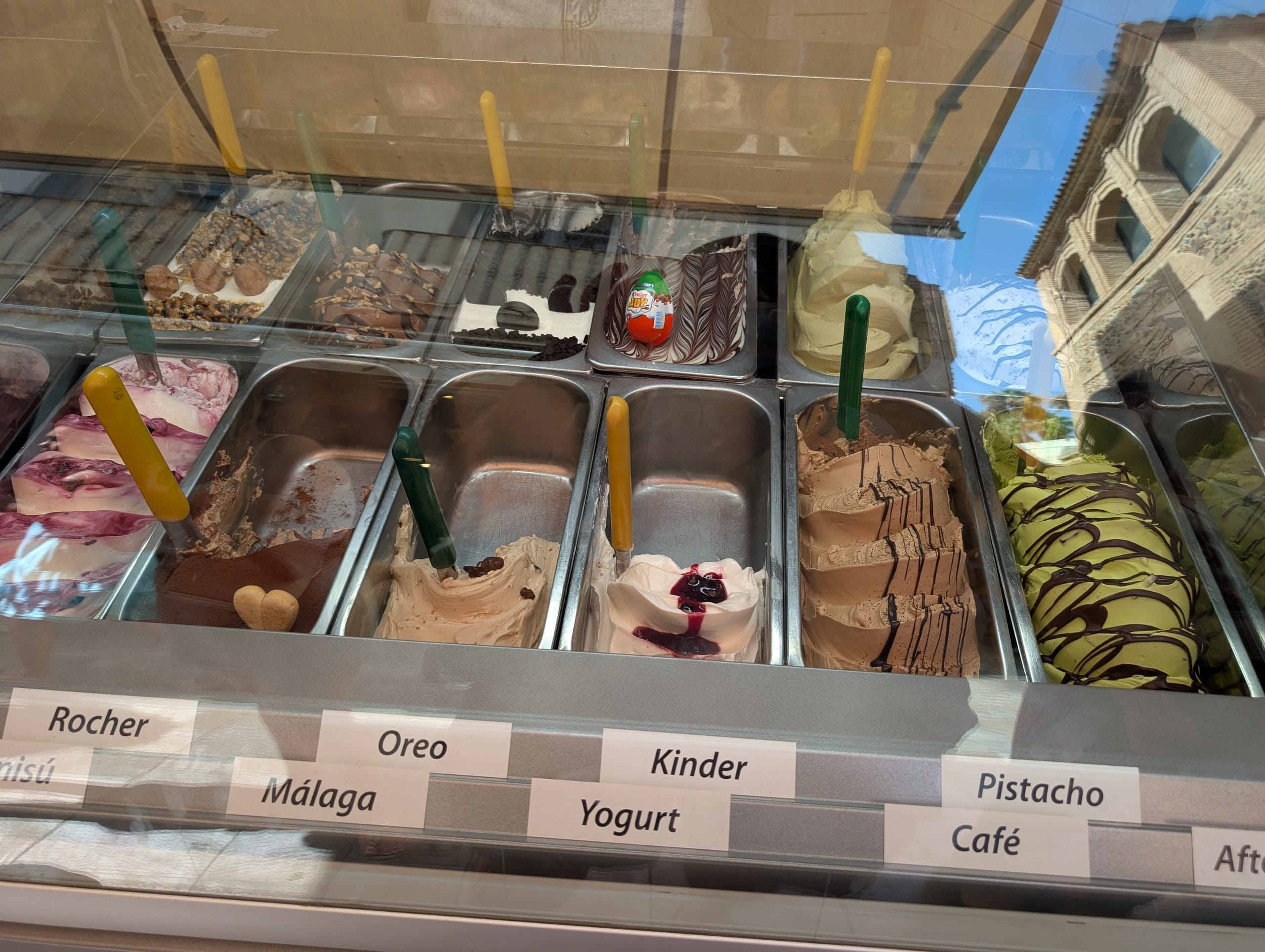 Gelato counter with trays of flavors at Freskitto in Málaga