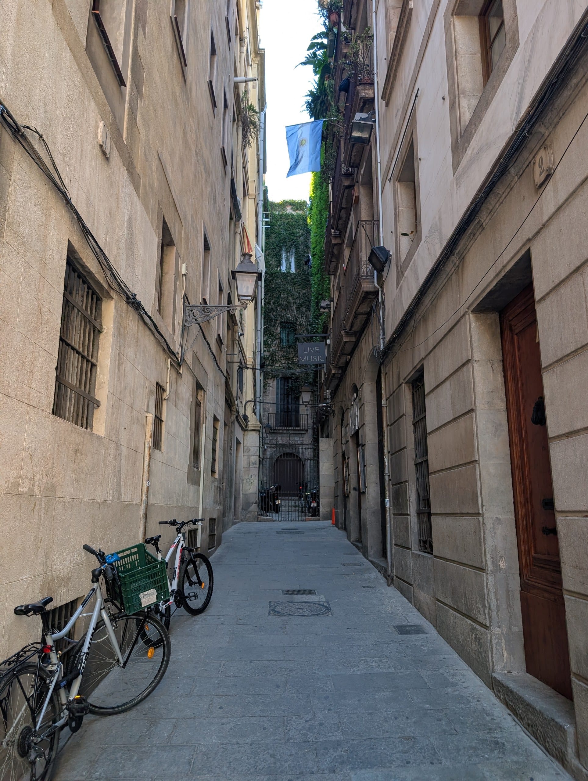 Bicycles parked against a wall in a narrow lane in the Gothic Quarter of Barcelona
