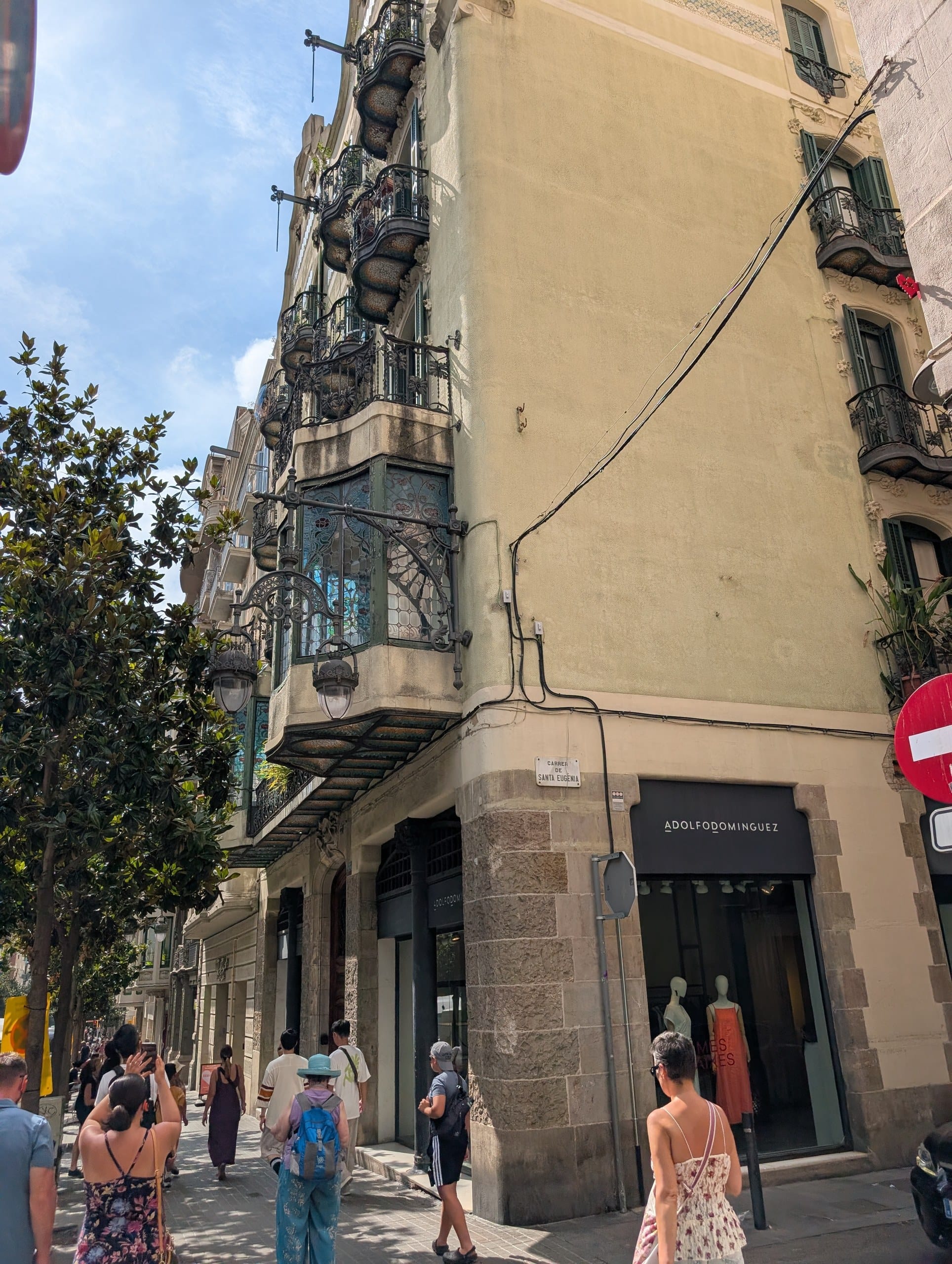 Modernista corner building with stacked iron balconies in Gràcia