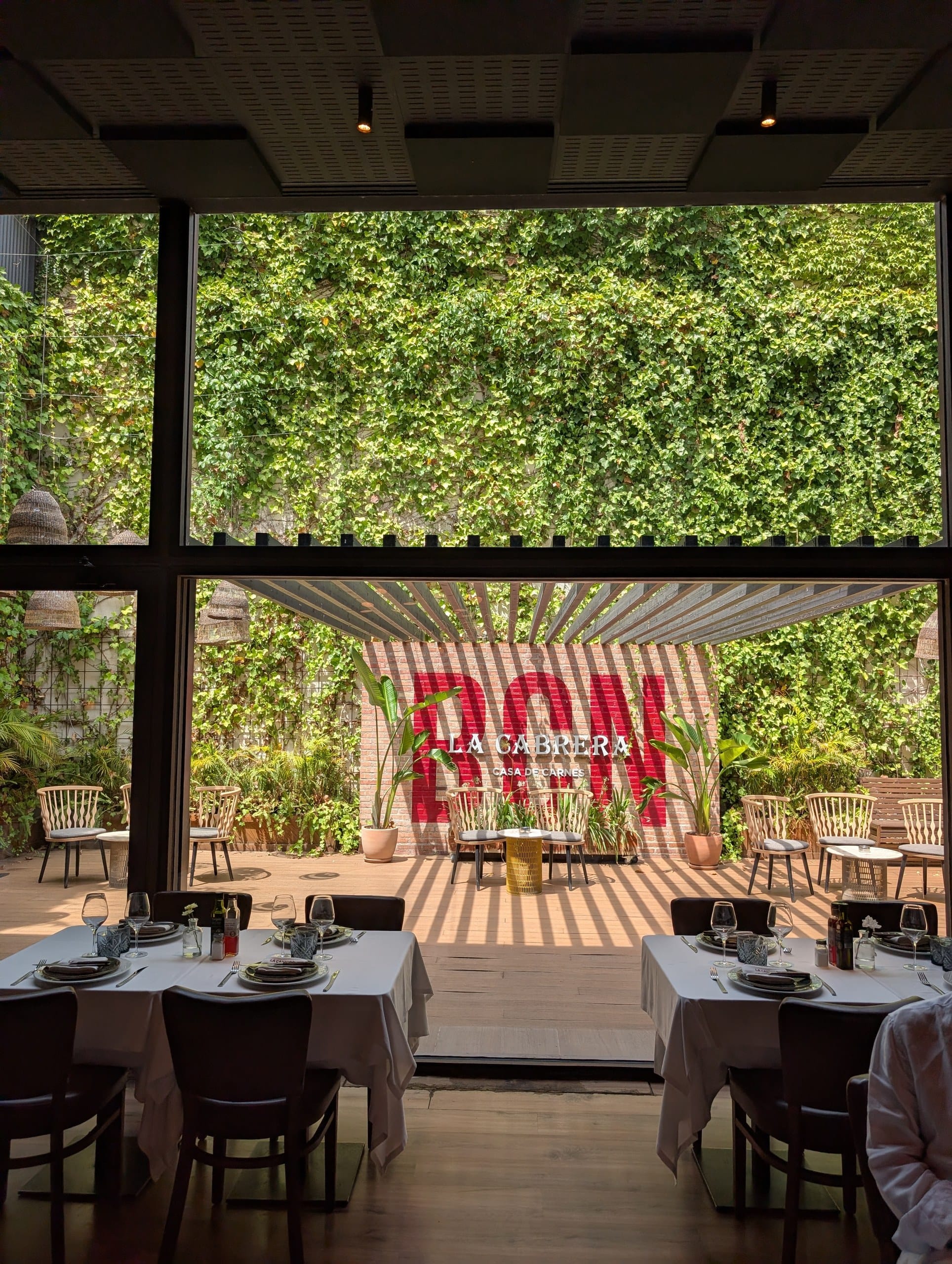 The planted interior courtyard at the back of La Cabrera Barcelona seen from the dining room