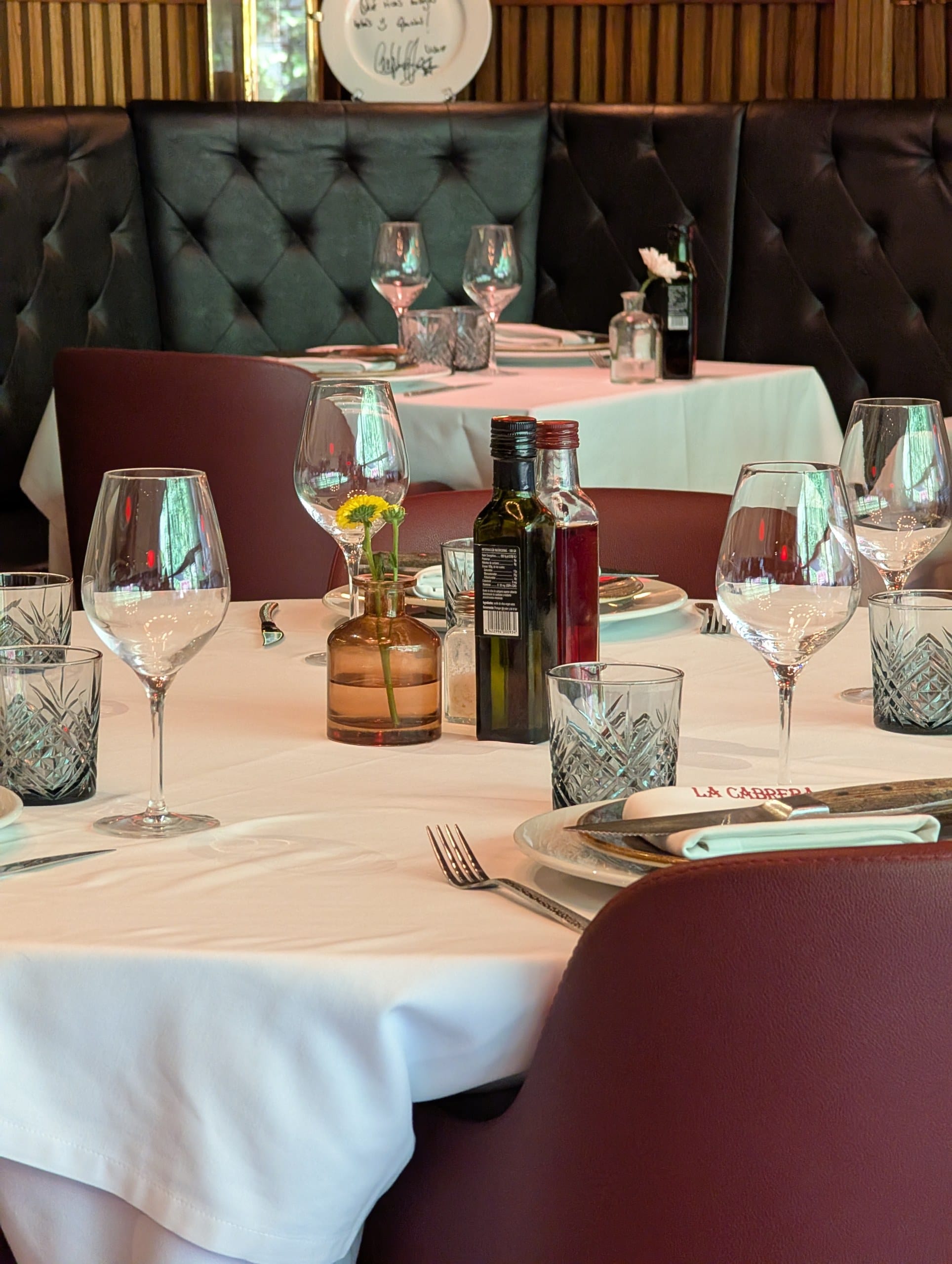 A laid table with oil and vinegar in the back dining room at La Cabrera Barcelona