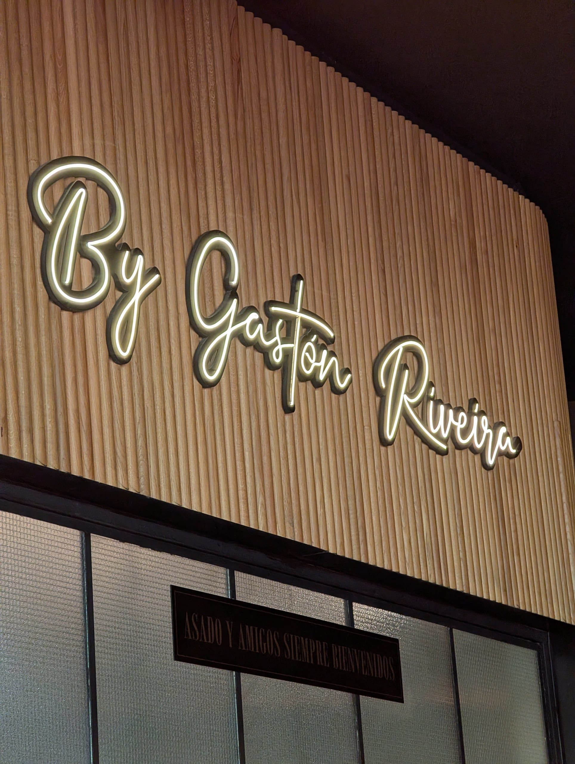 The lit By Gaston Riveira sign inside La Cabrera Barcelona