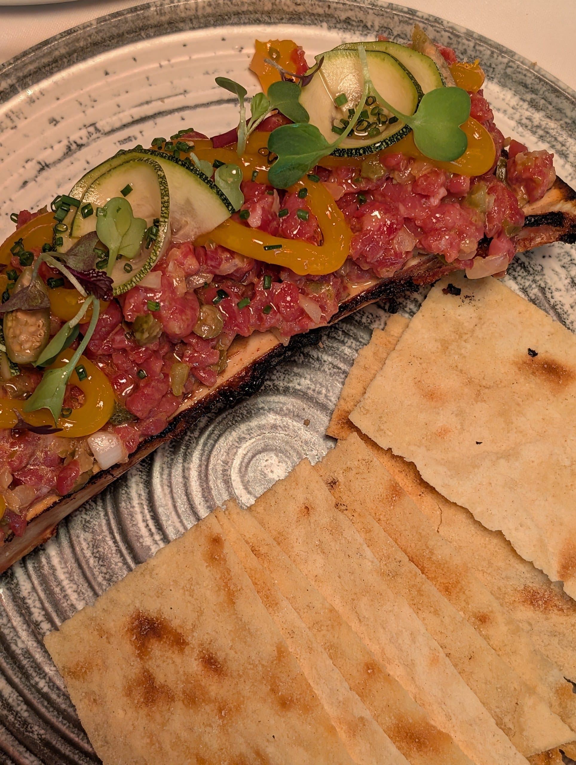 The steak tartare and its marrow bone with grilled flatbread at La Cabrera Barcelona