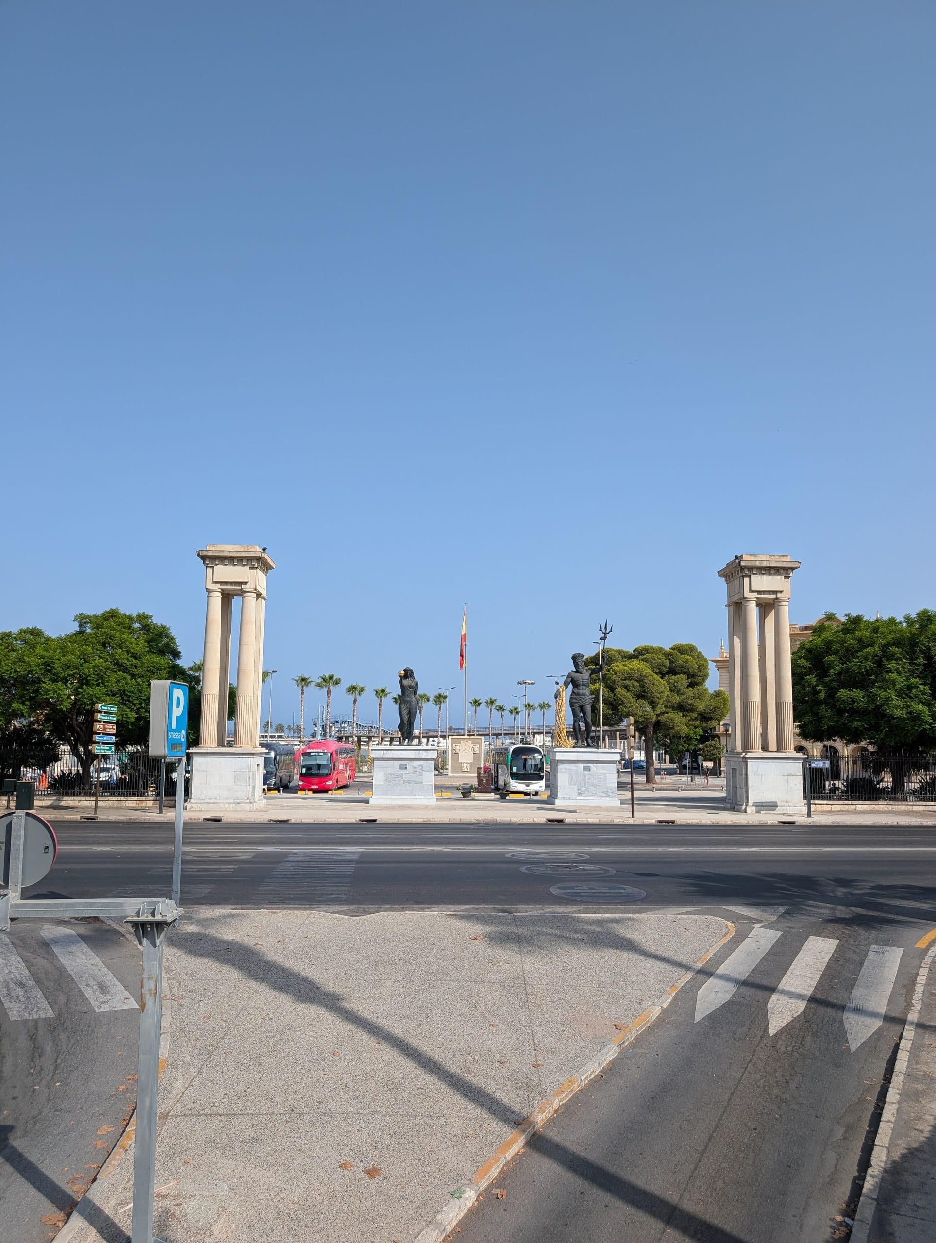 Columns at the pedestrian entrance to the Port of Malaga with bronze statues between them