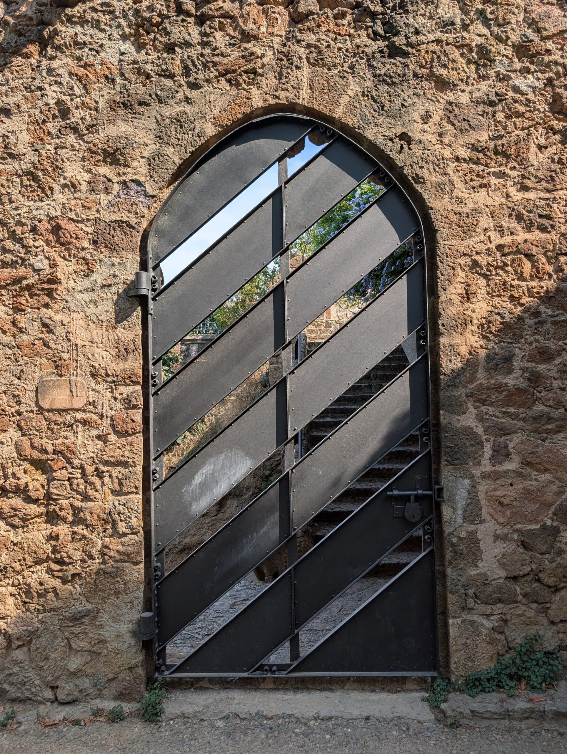 A gate in the perimeter wall of Park Guell in Barcelona