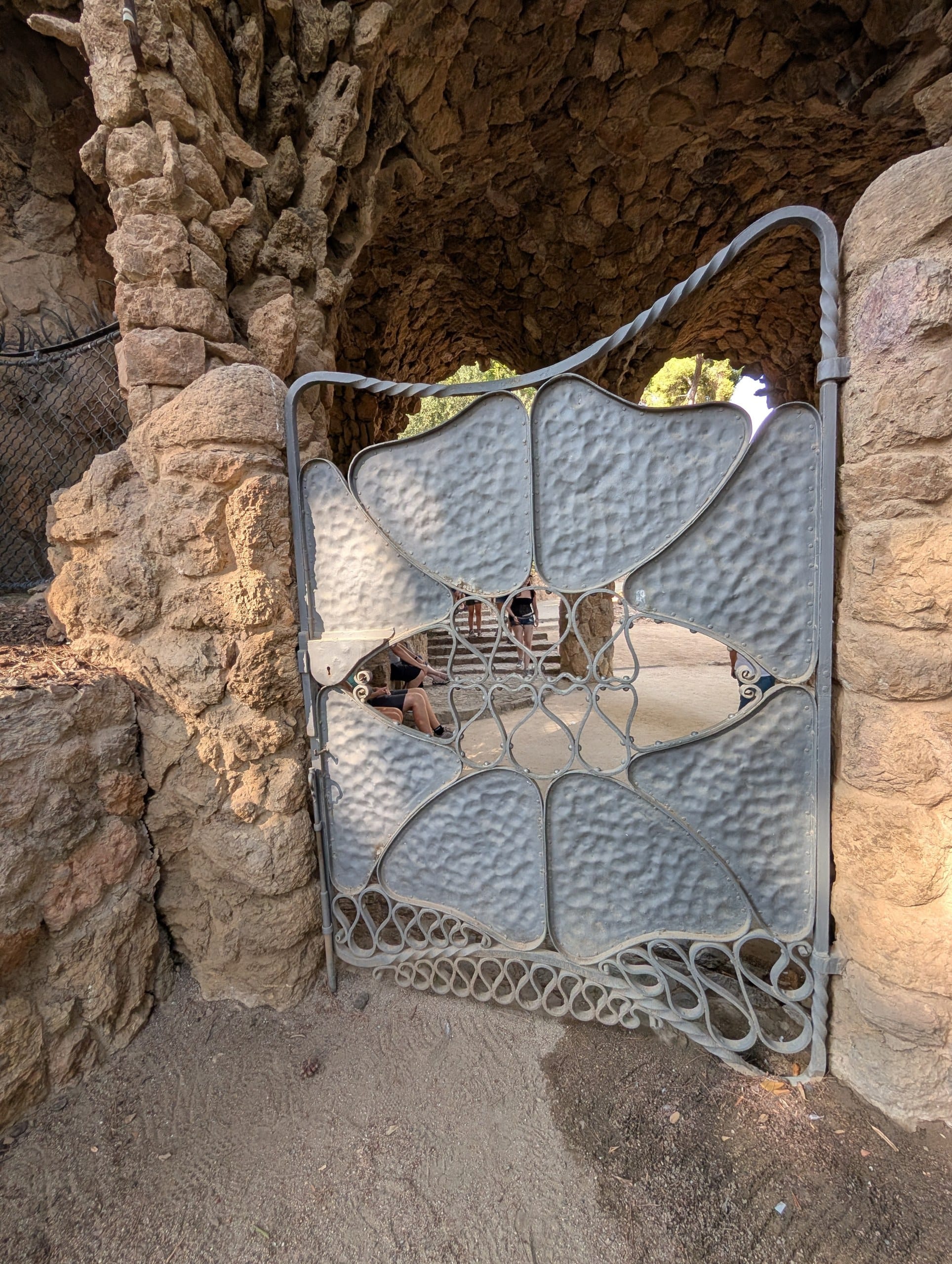 Ironwork gate detail set into the stonework at Park Guell