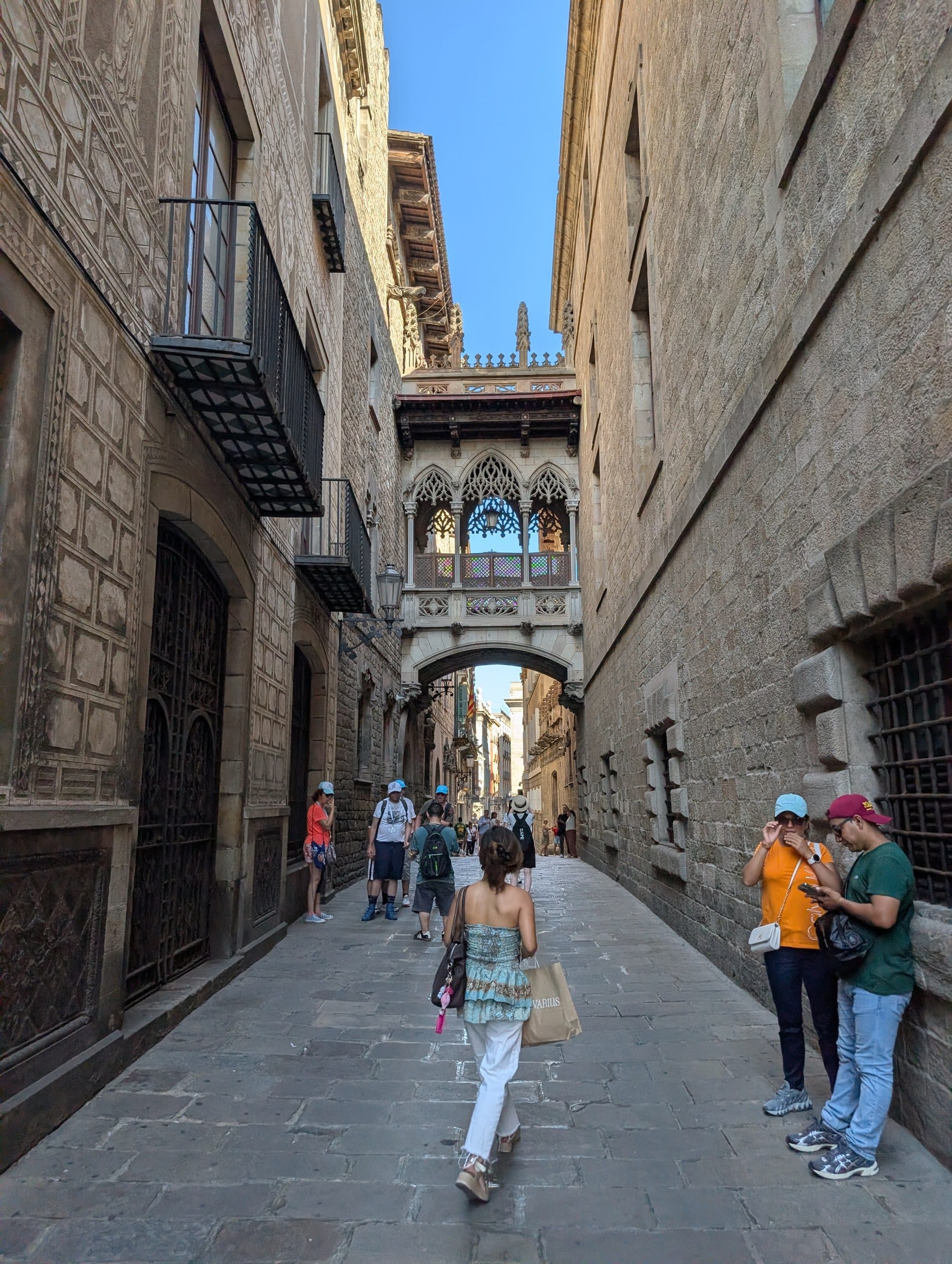 The carved stone Pont del Bisbe bridge spanning Carrer del Bisbe in the Gothic Quarter of Barcelona seen from below