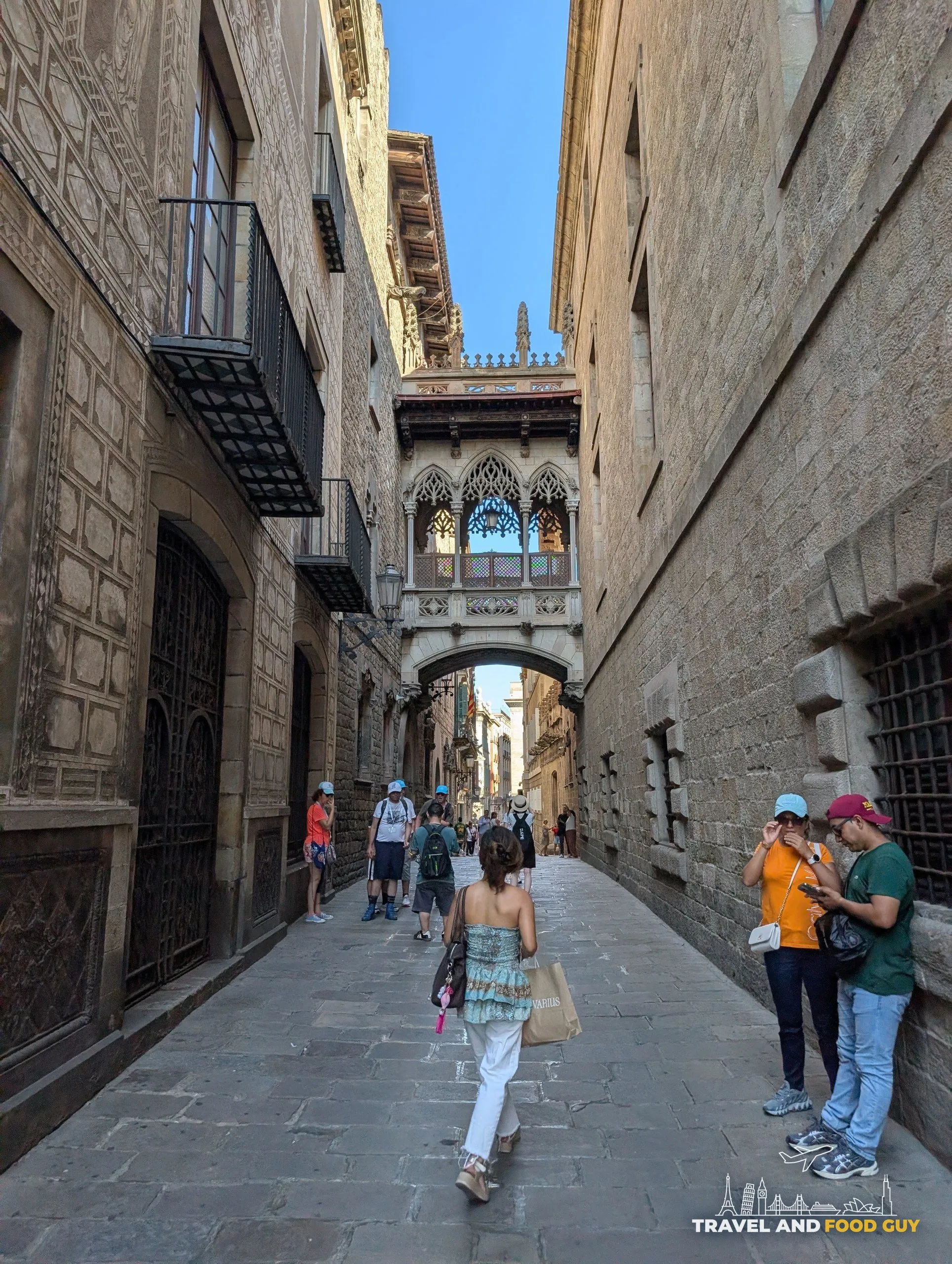 The carved stone Pont del Bisbe bridge spanning Carrer del Bisbe in the Gothic Quarter of Barcelona seen from below