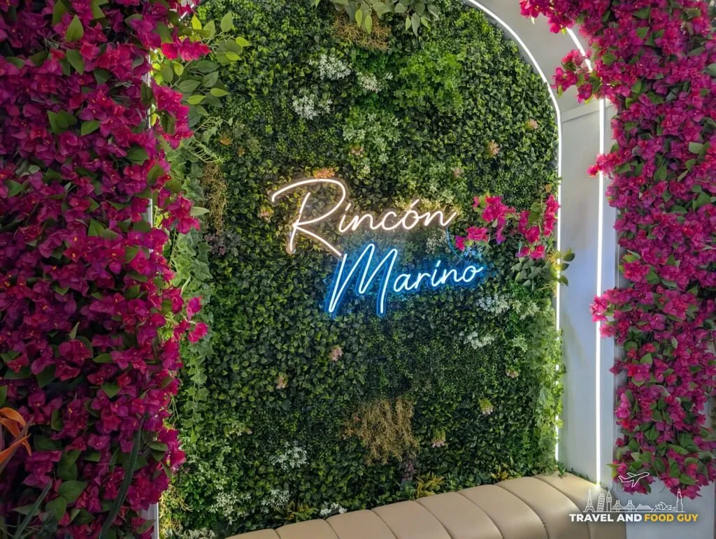 A greenery wall with neon lighting inside Rincón Marino in Barcelona