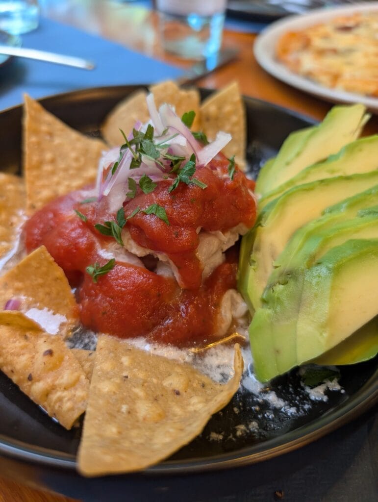 Shrimp and white fish ceviche with avocado and a bright red sauce at Rincón Marino