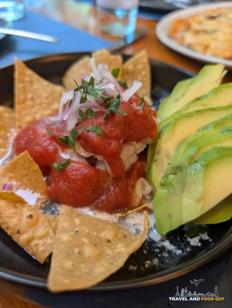 Shrimp and white fish ceviche with avocado and a bright red sauce at Rincón Marino
