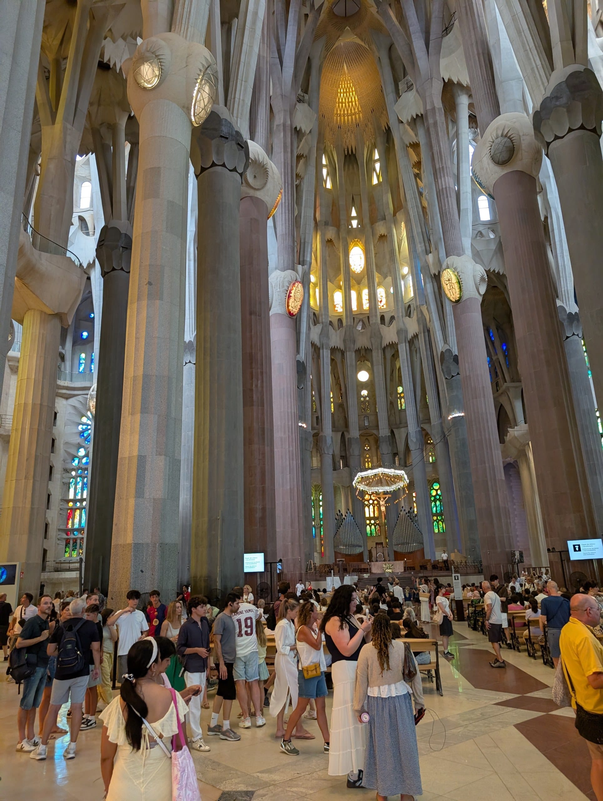 Crowds moving between the columns of the Sagrada Familia