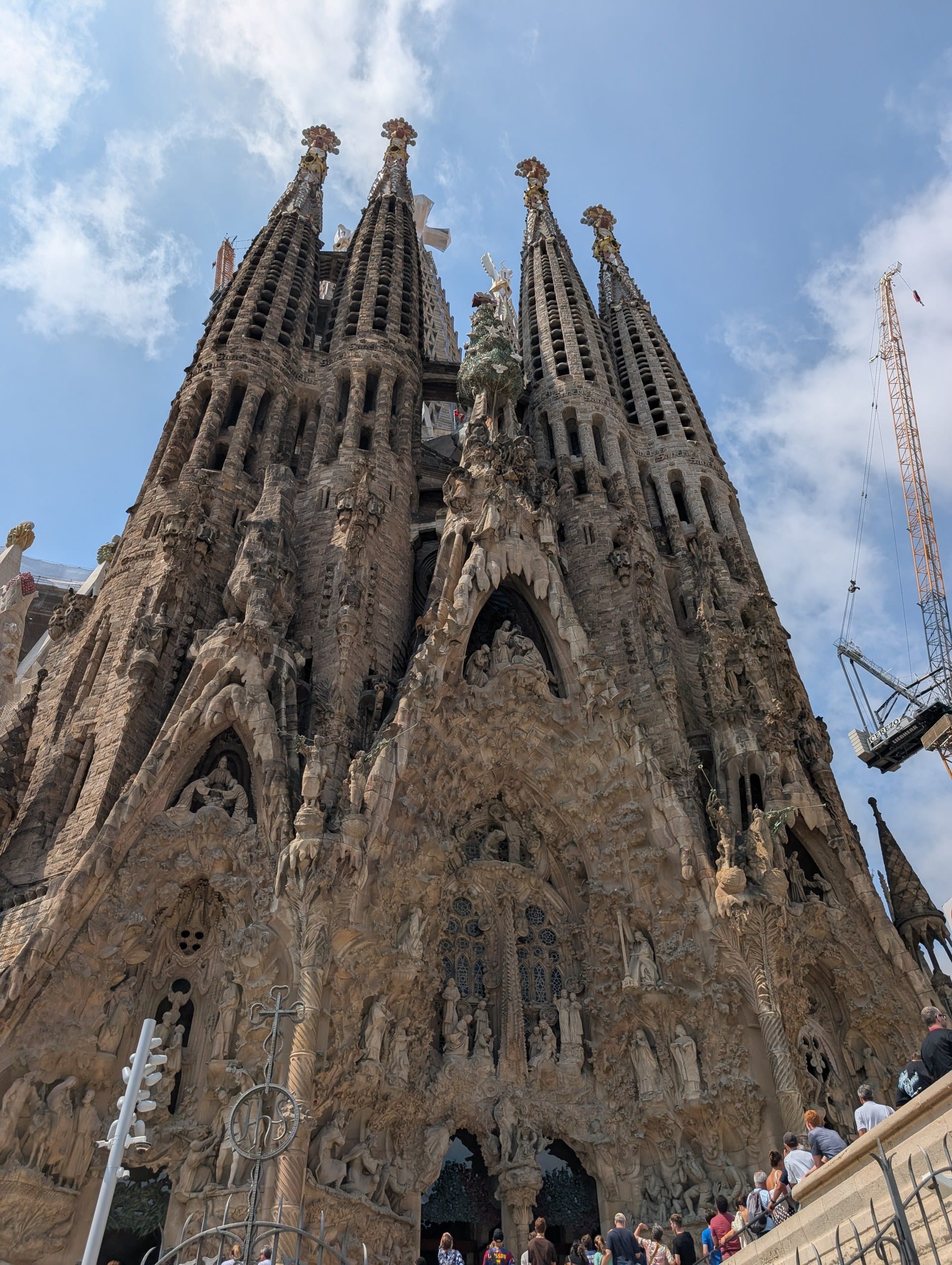The Sagrada Familia towers seen from below, cranes still working on the basilica