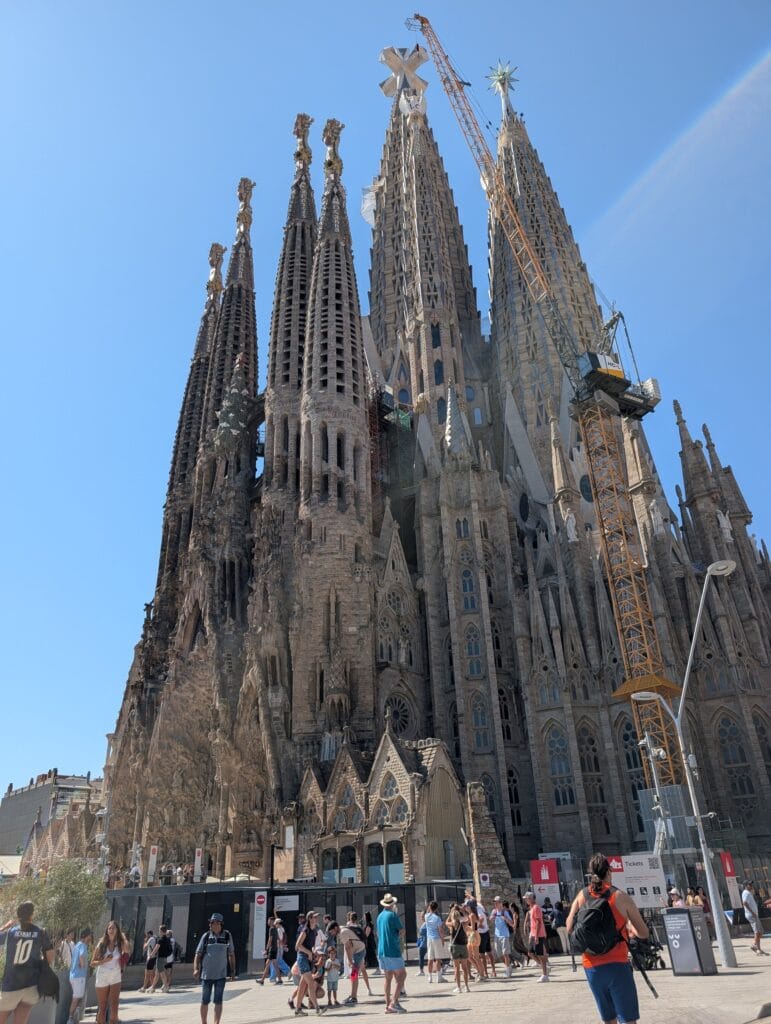 The Nativity facade of the Sagrada Familia with cranes above, seen from the first tuk tuk stop