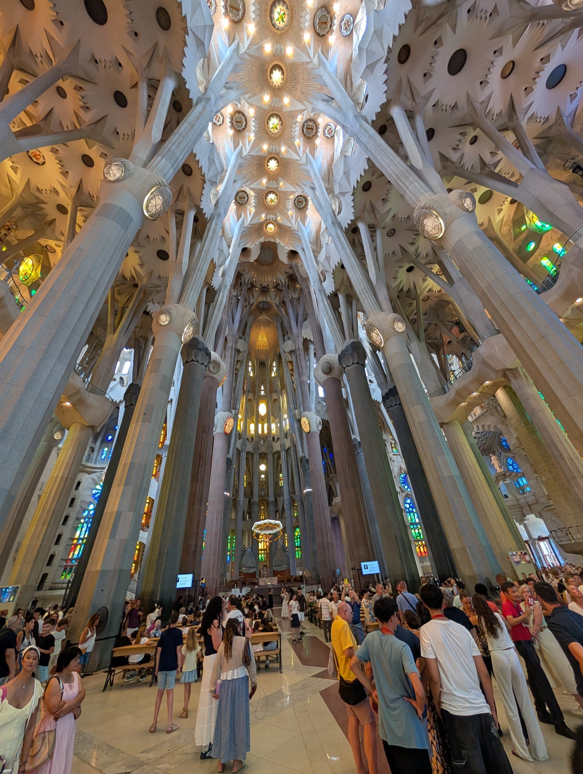Visitors filling the nave of the Sagrada Familia on an August afternoon
