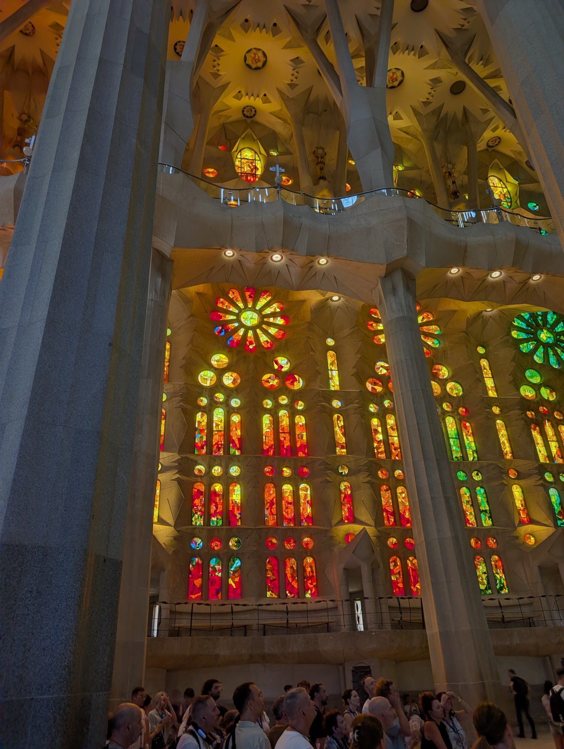 A wall of red and orange stained glass inside the Sagrada Familia