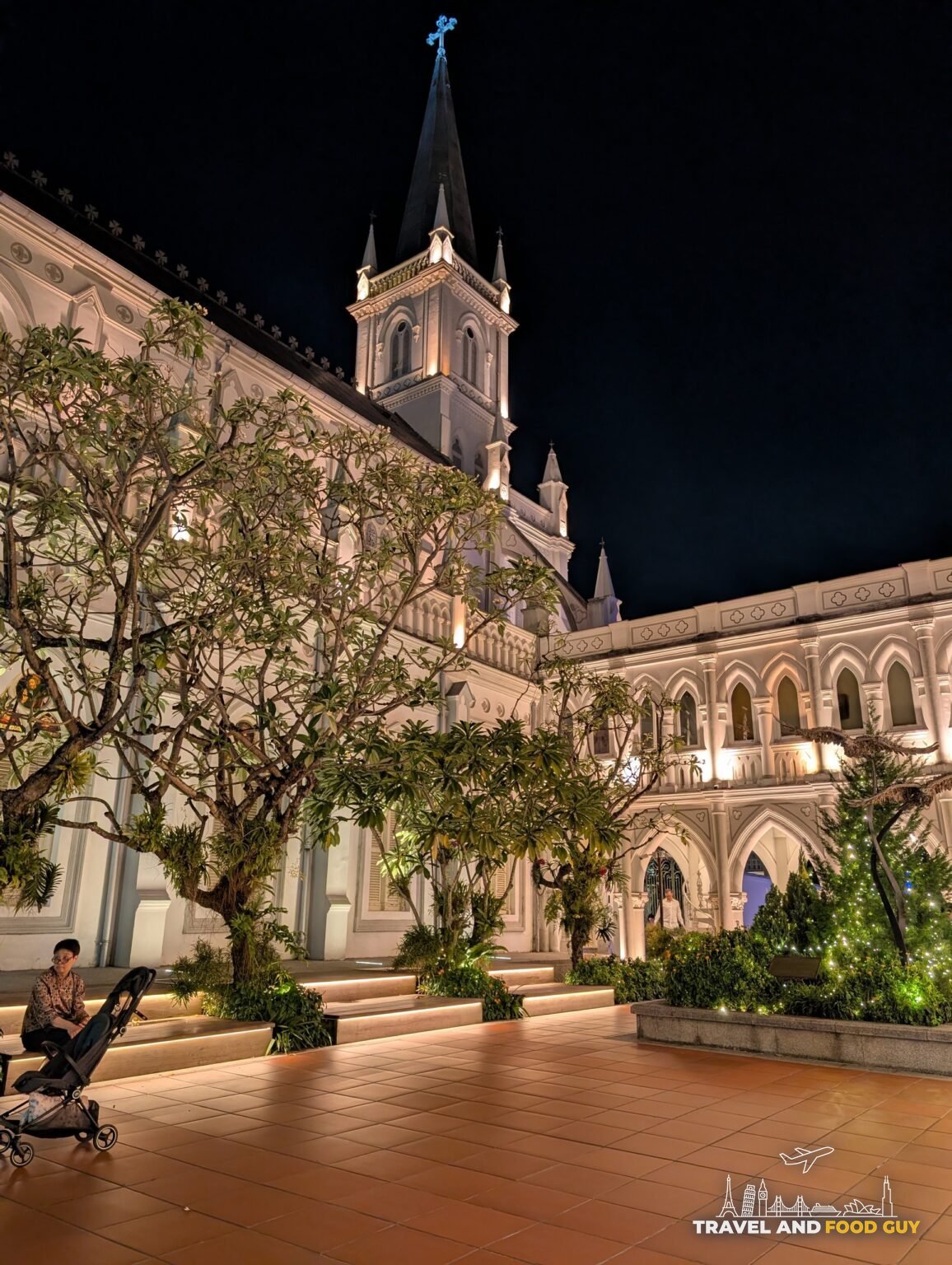 The illuminated gothic chapel spire and cloister courtyard at CHIJMES in the historic downtown area of Singapore
