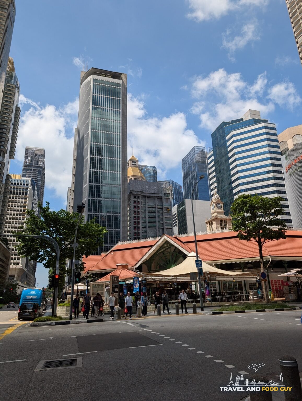 The Victorian cast iron pavilion and red tile roof of Lau Pa Sat hawker market in the Singapore CBD, surrounded by high-rise office towers