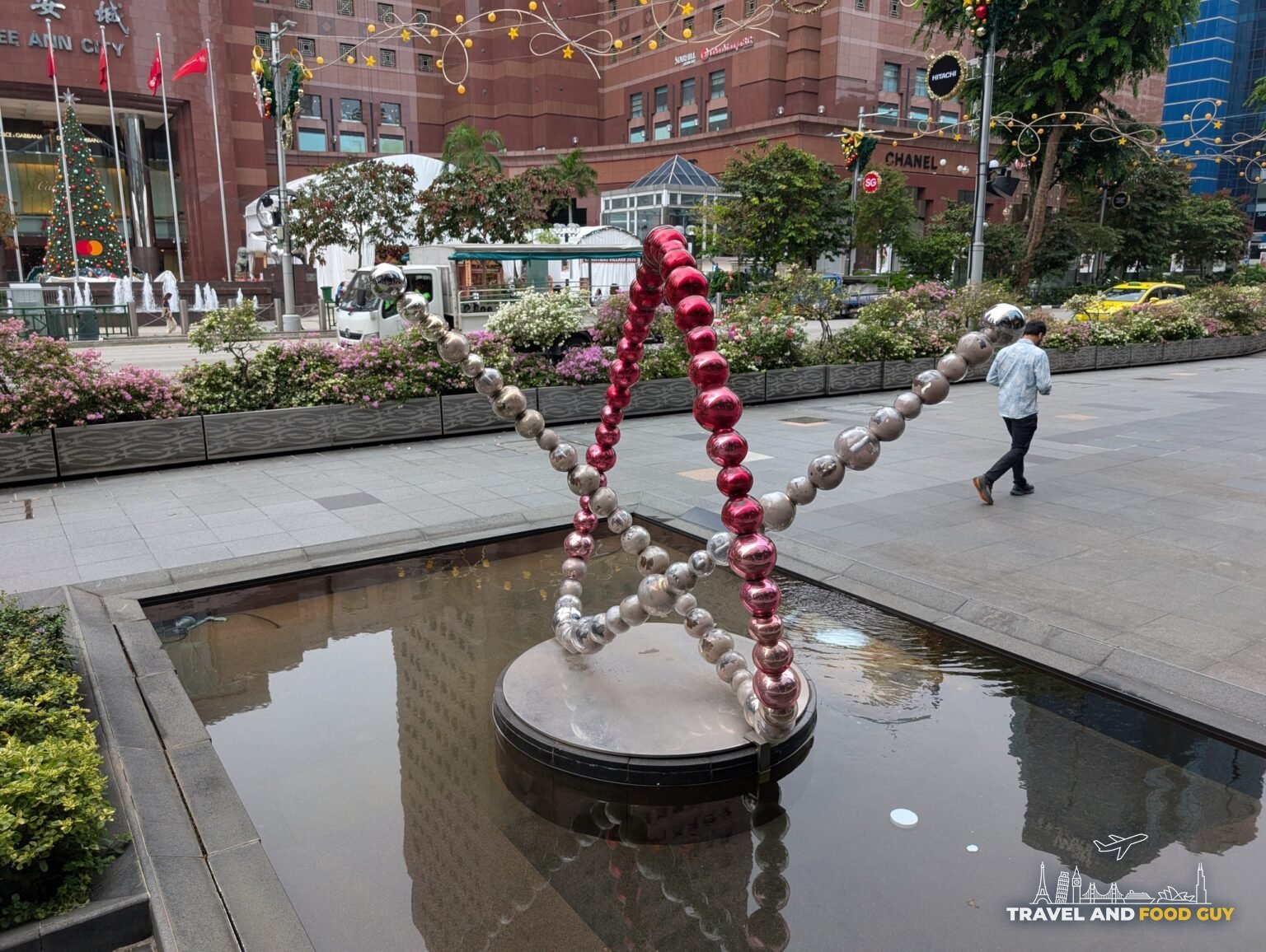 The pearl and red bauble Christmas star reflecting pool installation at Ngee Ann City on Orchard Road, Singapore